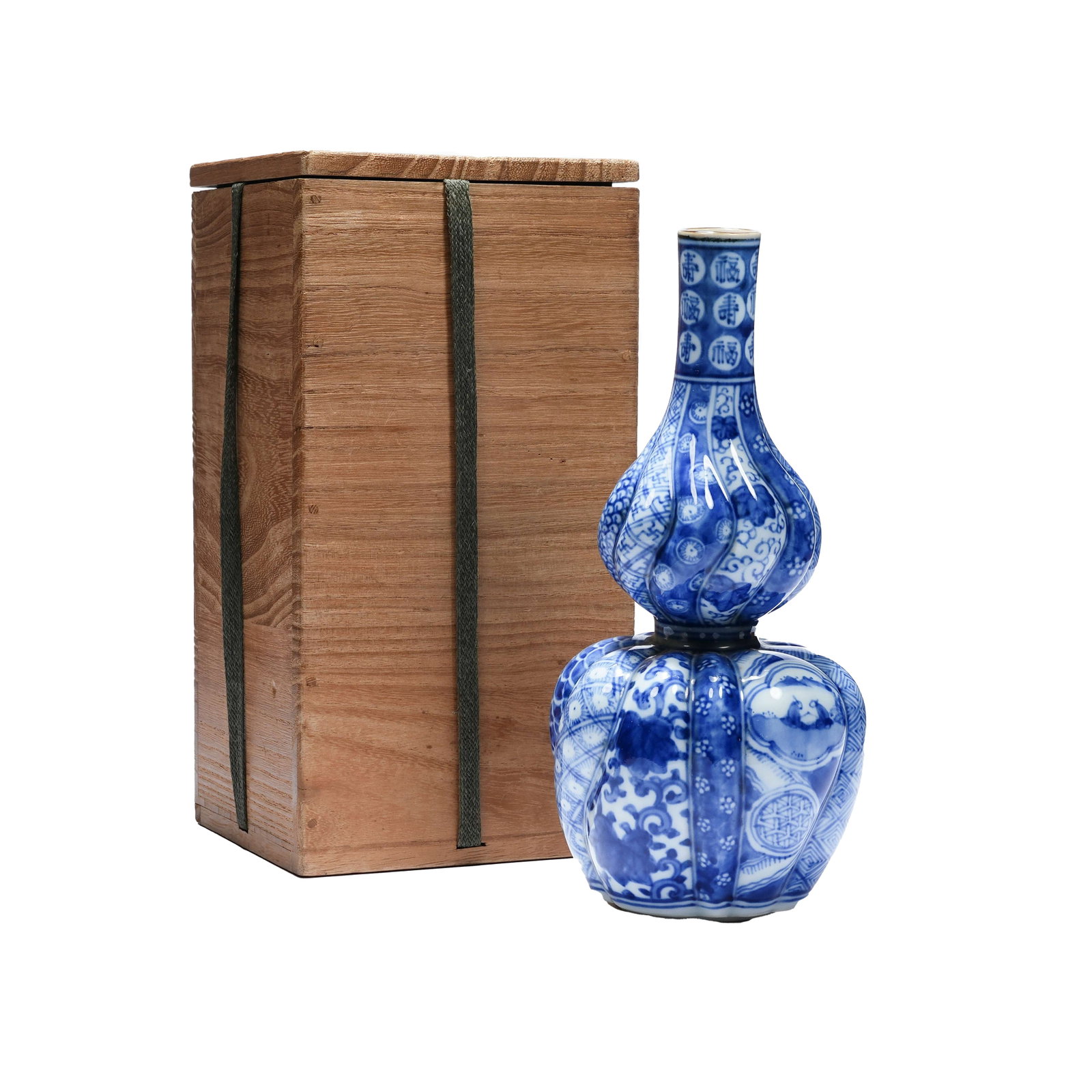 BLUE AND WHITE MELON-RIDGED GOURD VASE WITH FORTUNE AND LONGEVITY PATTERN, EARLY SHOWA PERIOD: This piece adopts the classic melon-ridged gourd shape with full and smooth lines. The whole body is fully decorated with blue and white painted patterns. Auspicious characters of blessing and longevi