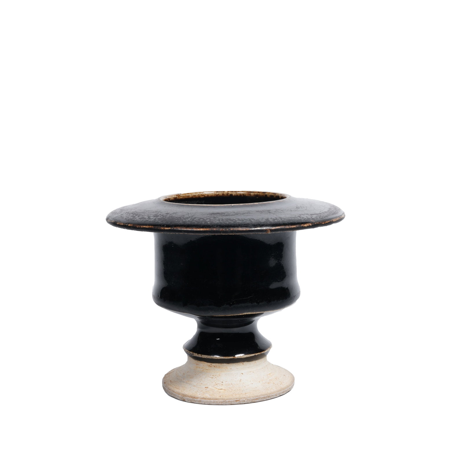 BLACK GLAZED STEM CUP-STYLE CENSER, SONG DYNASTY: This is a black-glazed incense burner produced in northern kilns of the Song Dynasty. Well-proportioned in shape, it is a typical Buddhist incense vessel. It features wide folded rim, slightly bulging