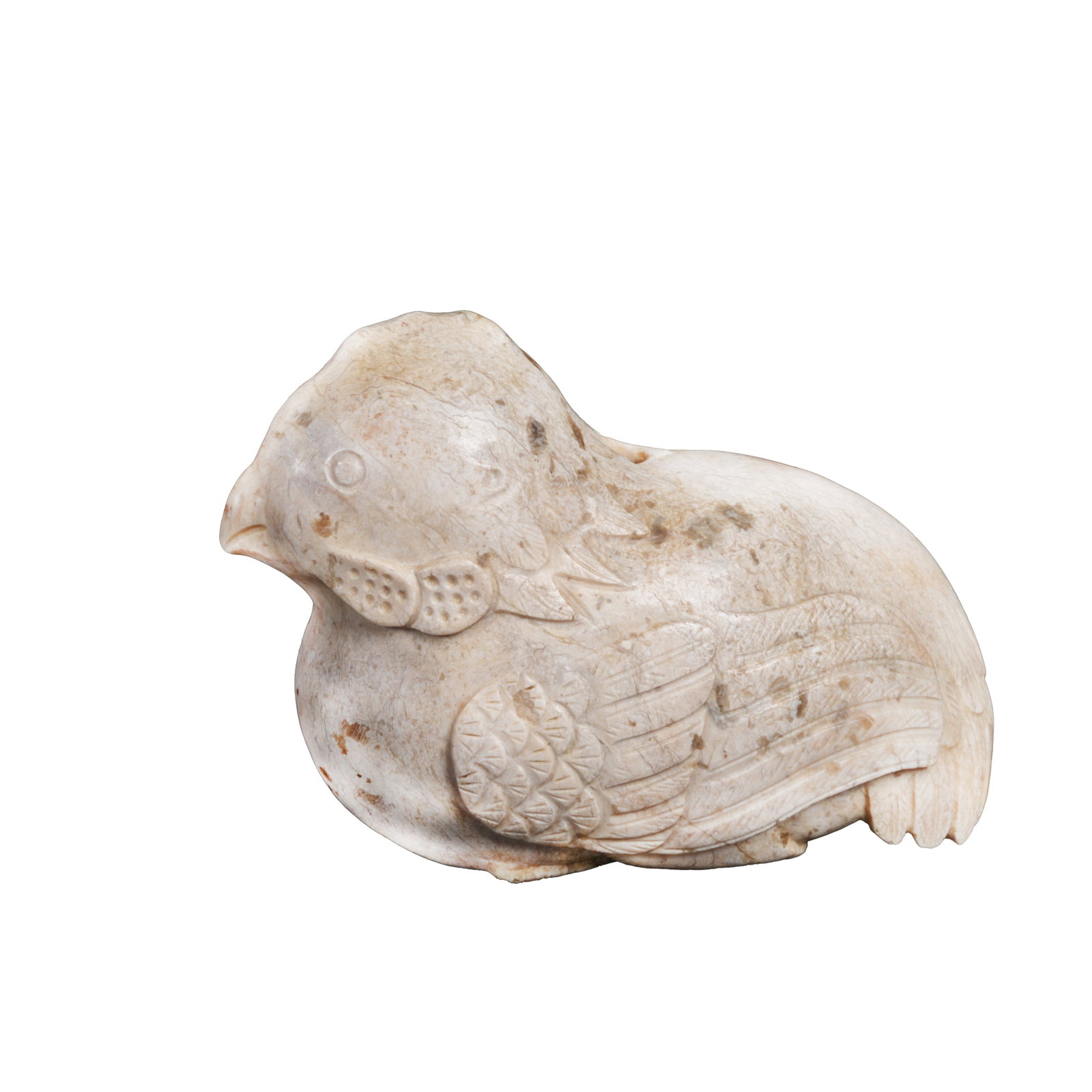 ROUND-CARVED CHICKEN-BONE WHITE JADE BIRD, HAN DYNASTY: This Han Dynasty reclining bird jade carving is made of Hotan jade. After thousands of years of burial, it presents typical chicken-bone white calcification from natural seepage. The jade is warm, fir