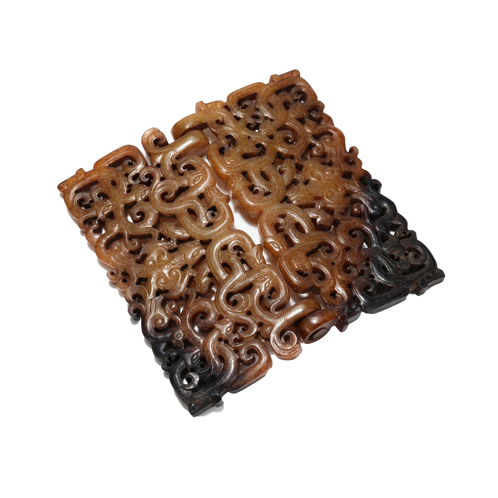 OPENWORK INTERLINKED PENDANT CARVED WITH DRAGON AND PHOENIX PATTERN, WARRING STATES PERIOD: Grouped ancient jade pendants of the Warring States Period are carved from a single piece of white Hotan jade with delicate and glossy texture, partially mottled with dark brown and ink-colored patina