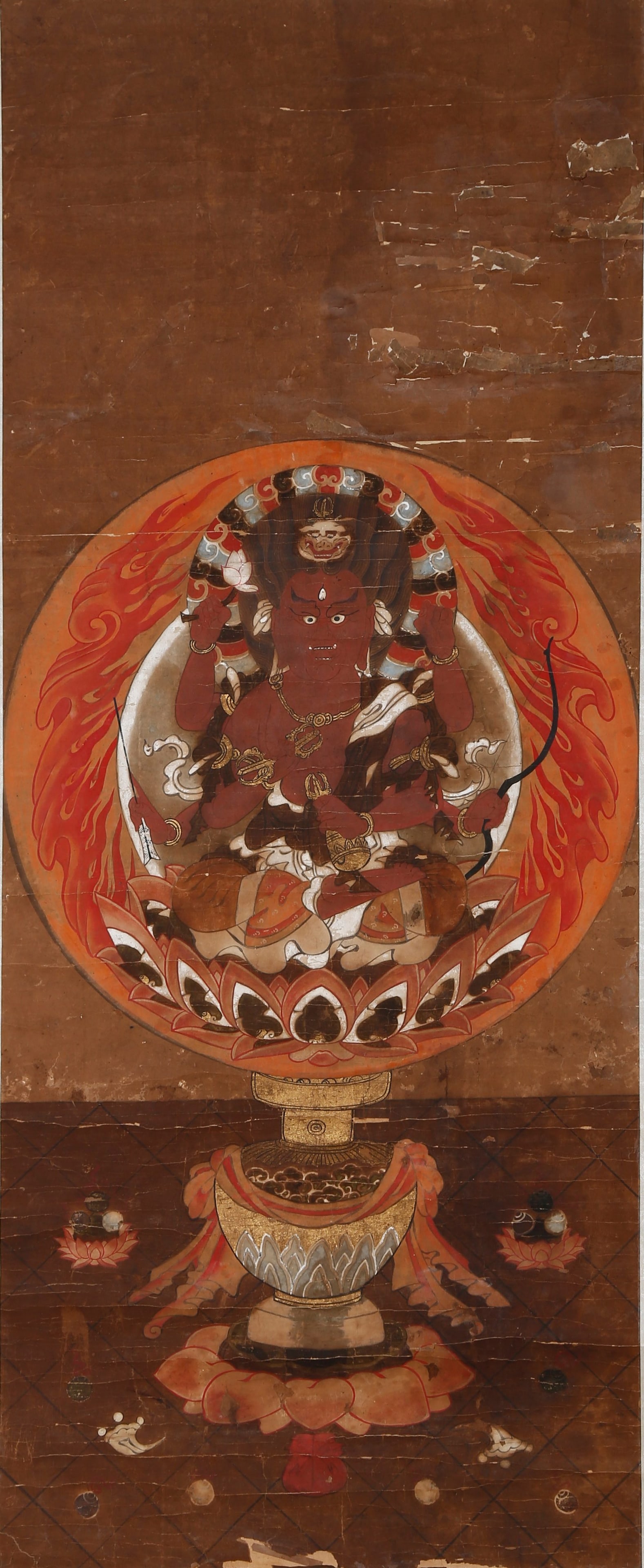 IMMOVABLE KING BUDDHA PAINTING ANONYMOUS MING DYNASTY.: The Wisdom King sits in full lotus posture on a lotus throne upheld by a precious vase. Dressed in crimson robes and adorned with a lion-faced precious crown, he is backed by a round halo decorated wi