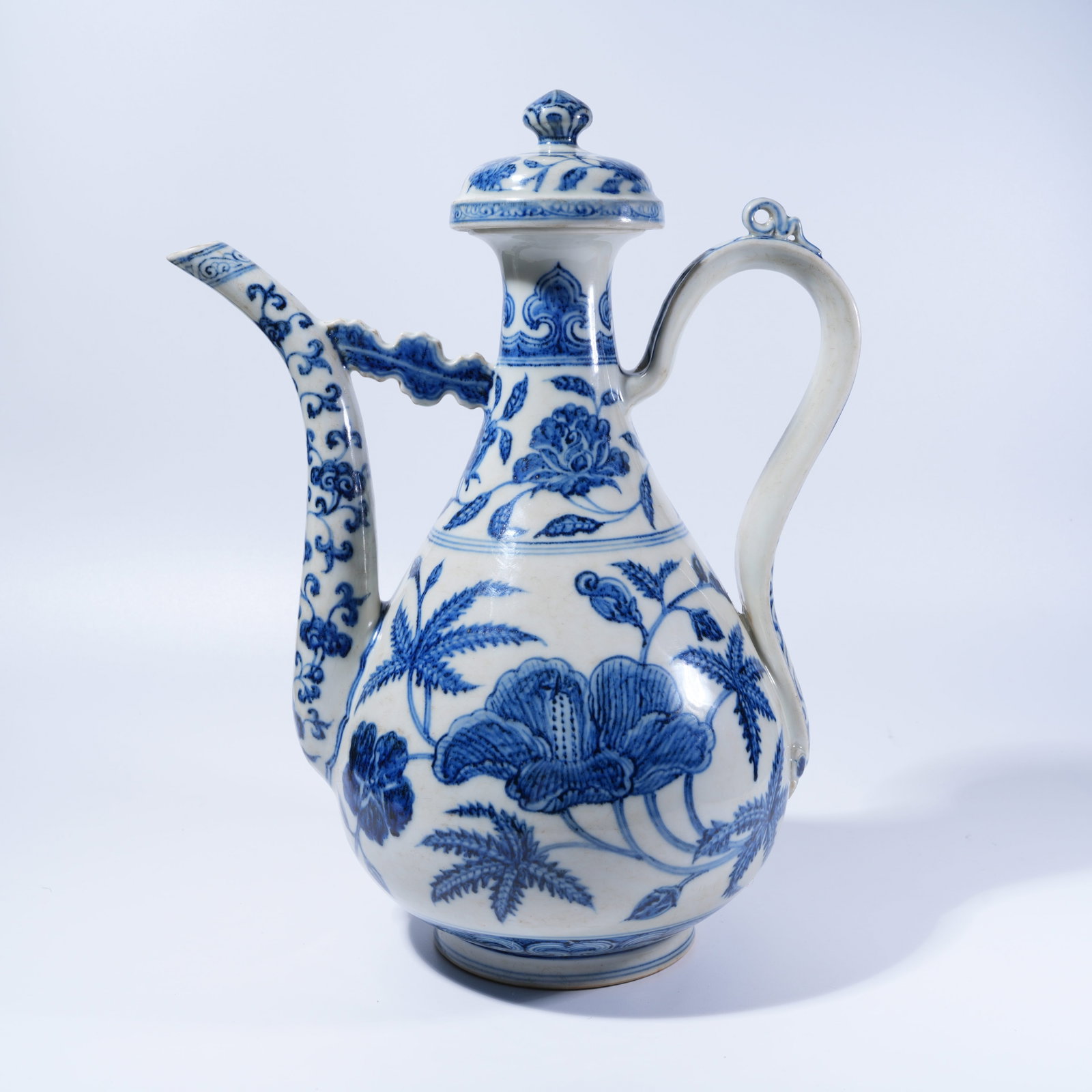 A BLUE AND WHITE EWER WITH FLORAL PATTERN: Blue and White Ewer with Floral Pattern