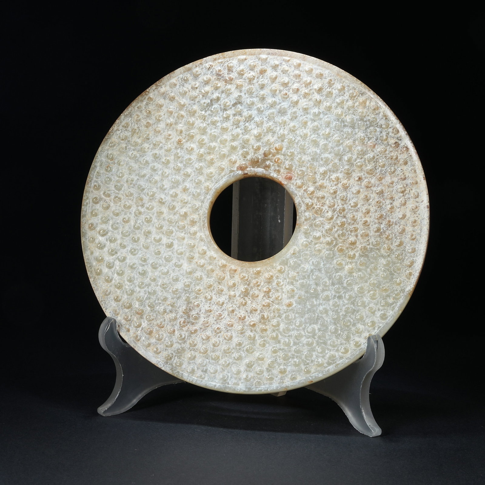 A ANCIENT JADE BI DISC WITH SCROLLED CLOUD PATTERN: Ancient Jade Bi Disc with Scrolled Cloud Pattern