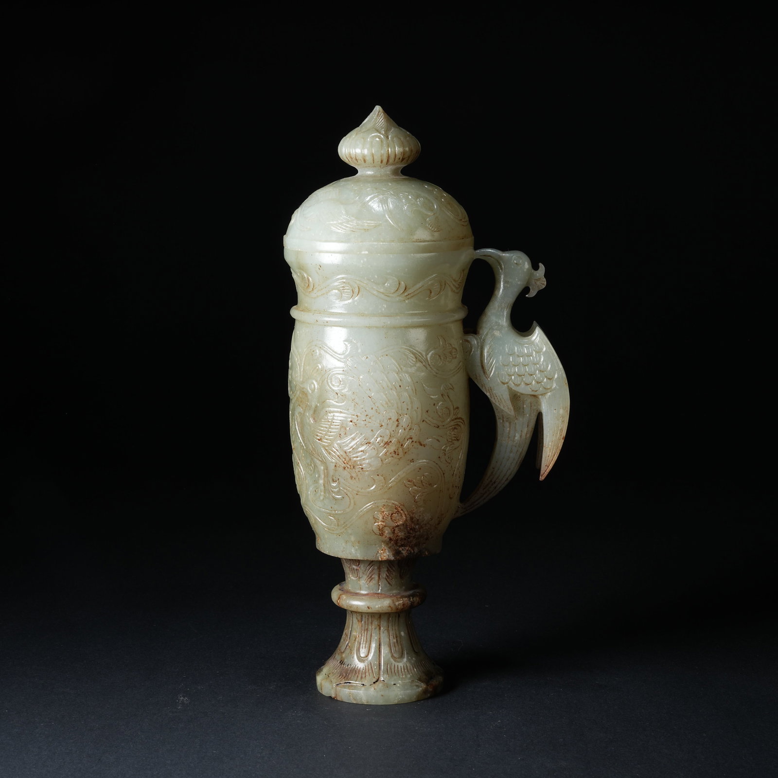 A ANCIENT JADE LIDDED CUP WITH PHOENIX HANDLE AND PHOENIX AMIDST FLORAL PATTERN: Ancient Jade Lidded Cup with Phoenix Handle and Phoenix Amidst Floral Pattern