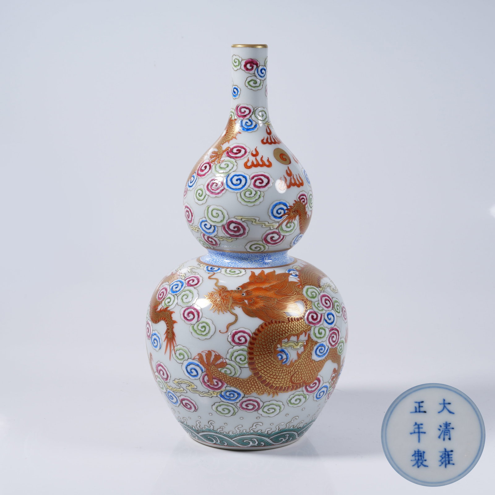 A IRON RED GILT GOURD VASE WITH CLOUD DRAGON PATTERN: Iron Red Gilt Gourd Vase with Cloud Dragon Pattern
