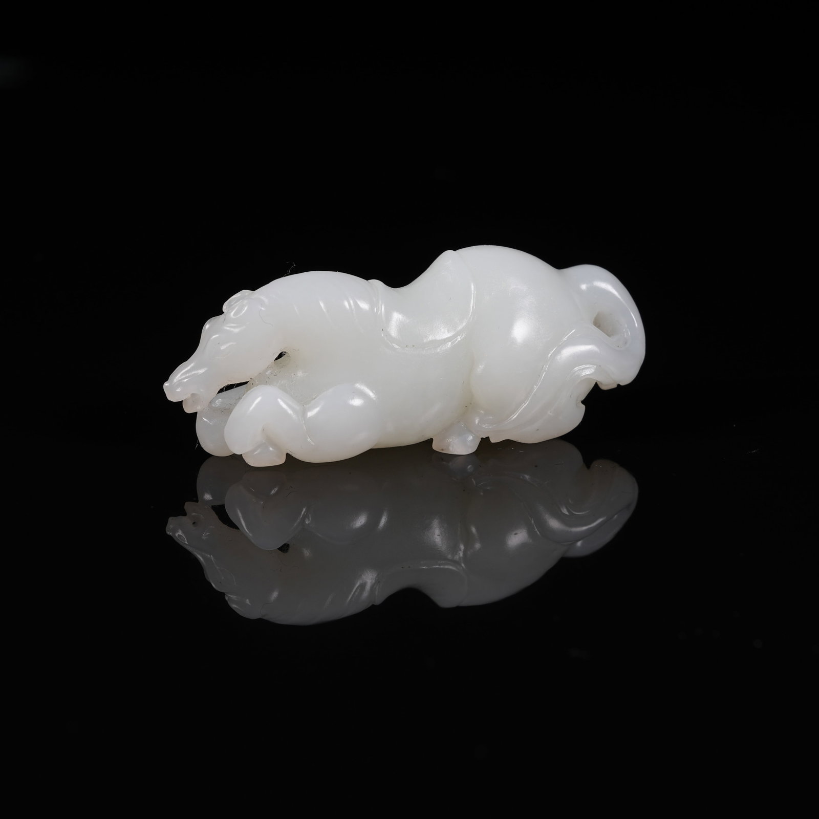 A WHITE HETIAN JADE RECLINING HORSE ORNAMENT (1 of 10)