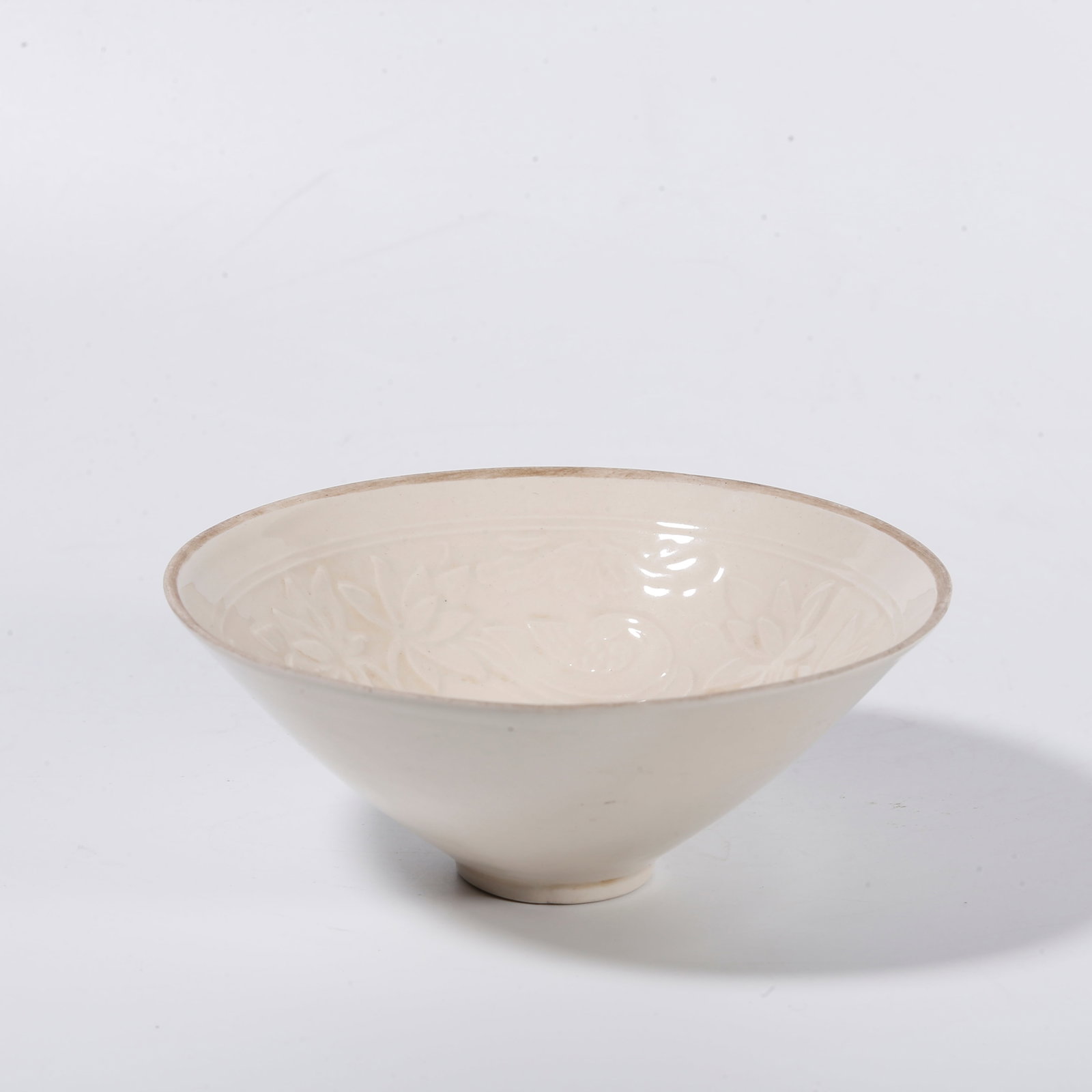 A DING KILN CUP WITH FLORAL PATTERNS: Ding Kiln Cup with Floral Patterns
