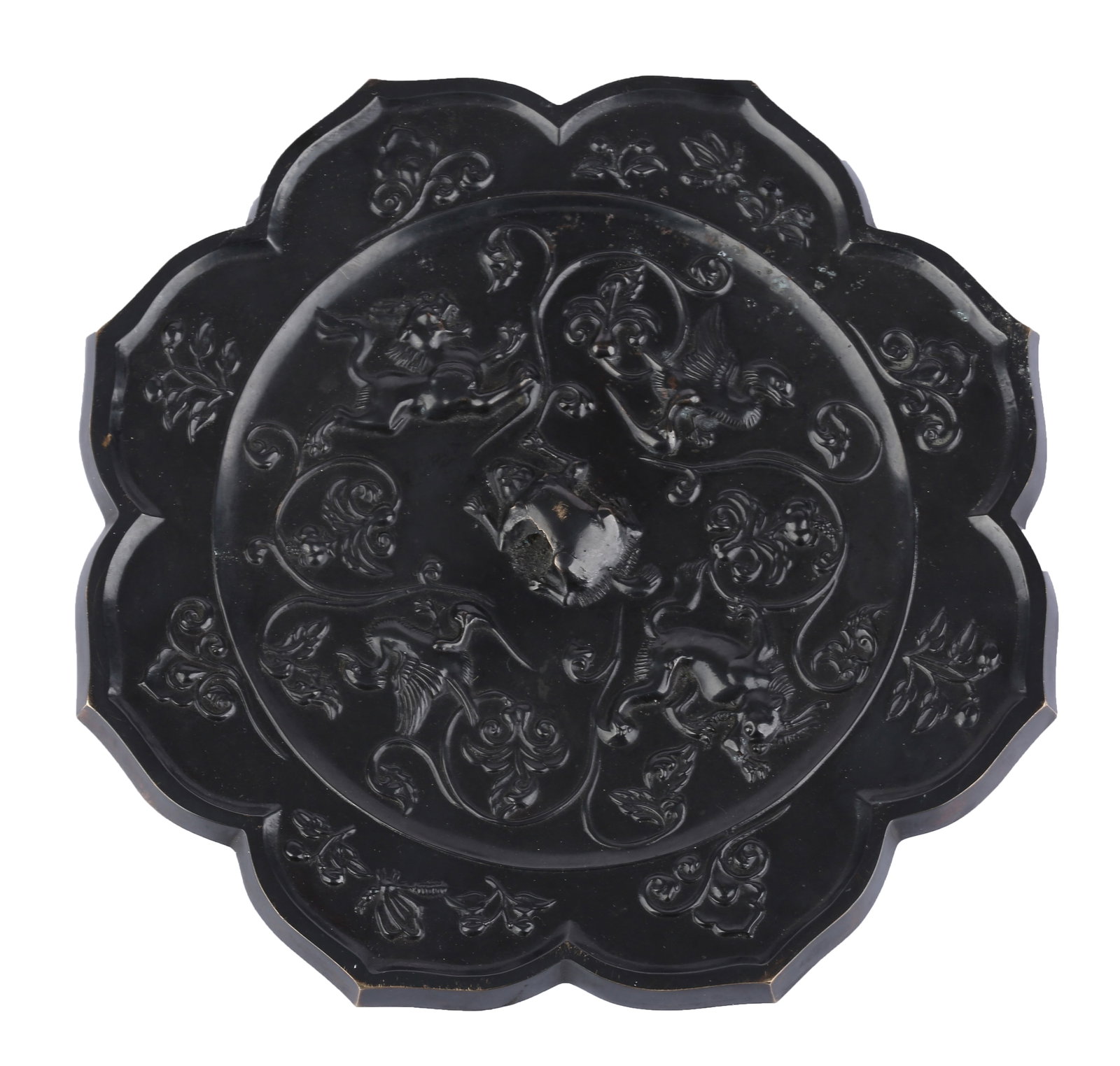 BLACK PATINATED BRONZE RHOMBUS MIRROR CARVED WITH AUSPICIOUS BEASTS, FLOWERS AND BIRDS, TANG DYNASTY: This is a Tang Dynasty rhombus-flower bronze mirror decorated with auspicious beasts, birds and floral patterns, a classic bronze mirror style of the prosperous Tang period. The rim takes the shape of