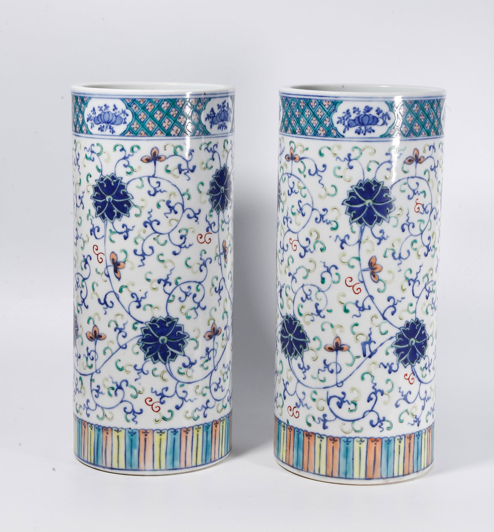 A PAIR OF DOUCAI HAT TUBES WITH INTERLOCKING FLORAL SCROLLS: Pair of Doucai Hat Tubes with Interlocking Floral Scrolls