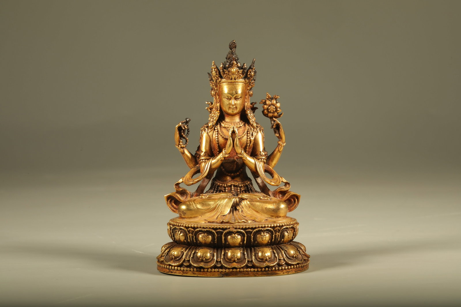 A GILT BRONZE STATUE OF FOUR-ARMED GUANYIN: Gilt Bronze Statue of Four-Armed Guanyin