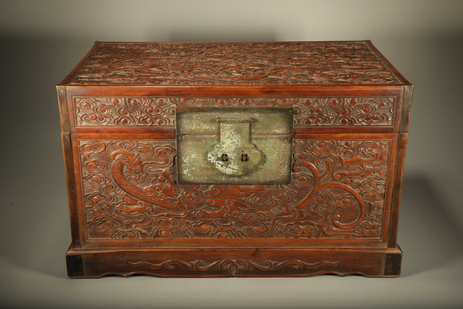 A PADAUK BOOK CHEST CARVED WITH CLOUD AND DRAGON PATTERNS: Padauk Book Chest Carved with Cloud and Dragon Patterns