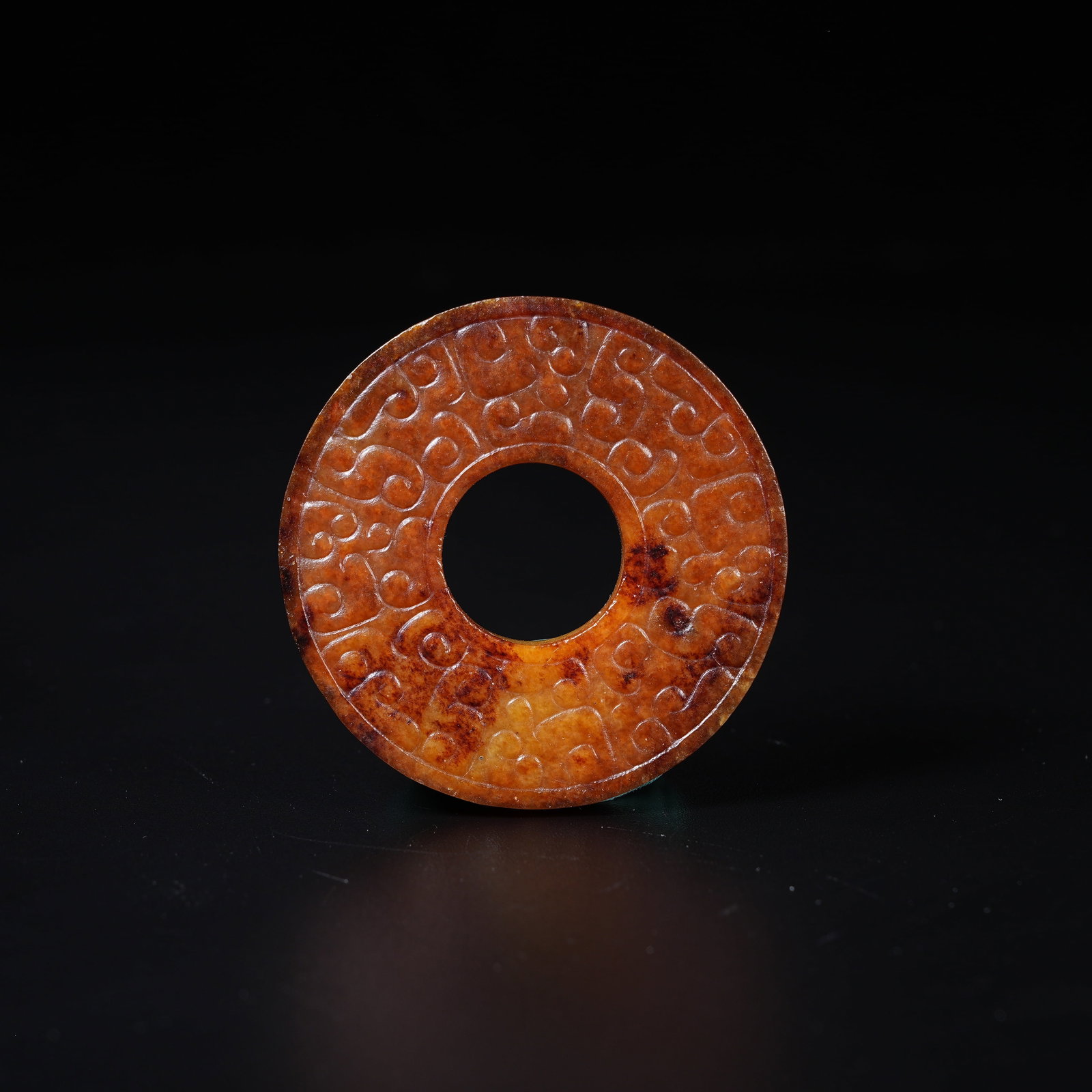 A ANCIENT JADE BI DISC WITH HOOKED CLOUD PATTERN: Ancient Jade Bi Disc with Hooked Cloud Pattern
