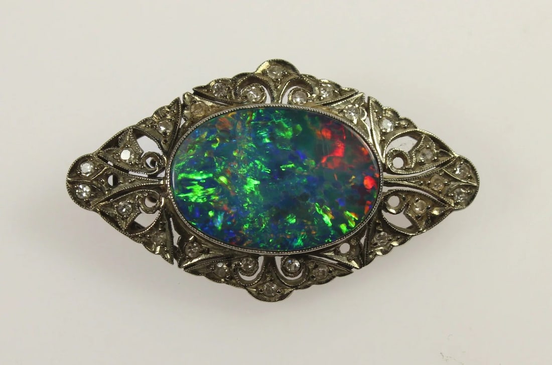 ANTIQUE BLACK OPAL BROOCH IN 15CT WHITE GOLD SETTING WITH OLD-CUT DIAMONDS: Antique Black Opal Brooch in 15ct White Gold setting with Old-cut Diamonds