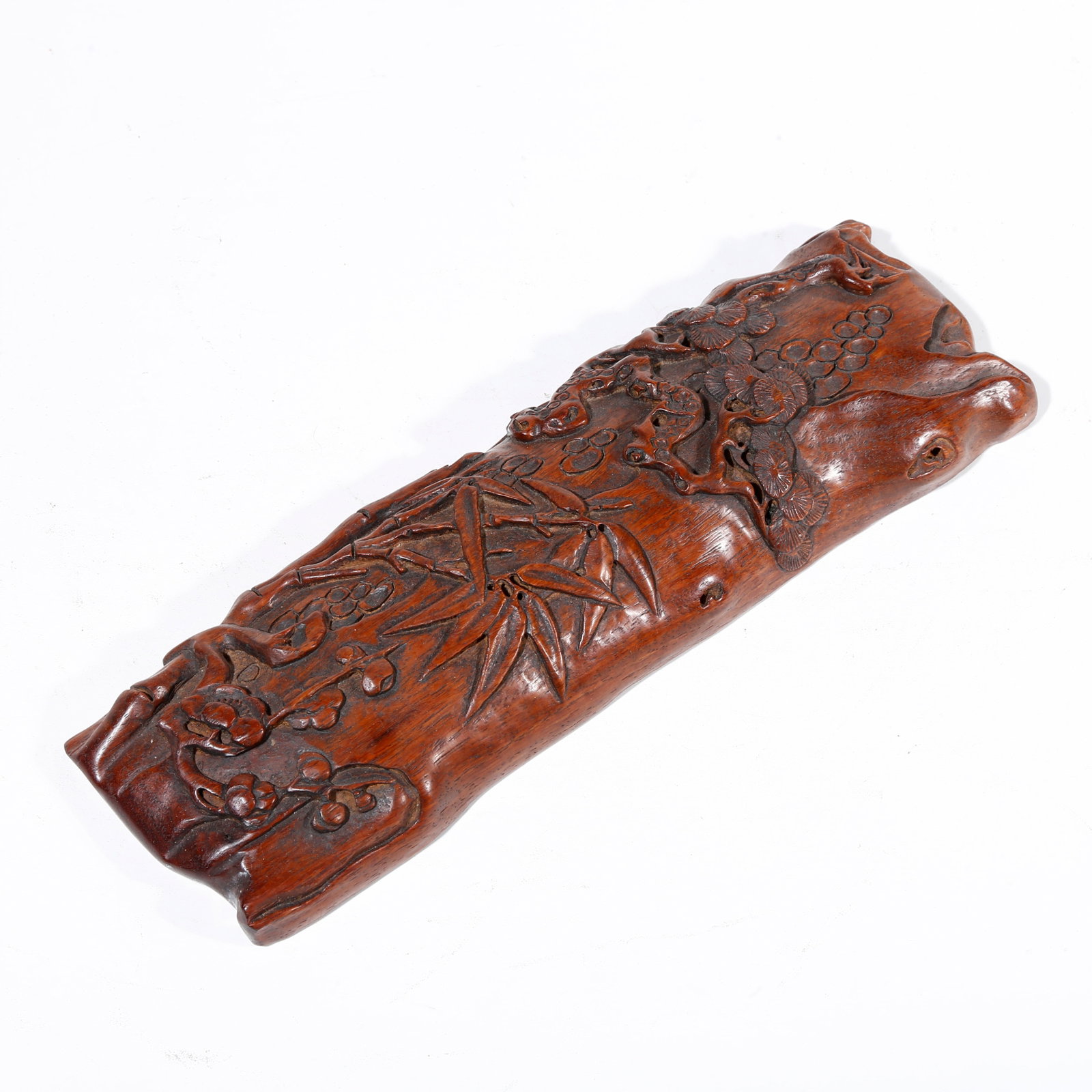 A HUANGHUALI WOOD CARVED ARM REST WITH PINE, PLUM AND BAMBOO PATTERN (1 of 9)