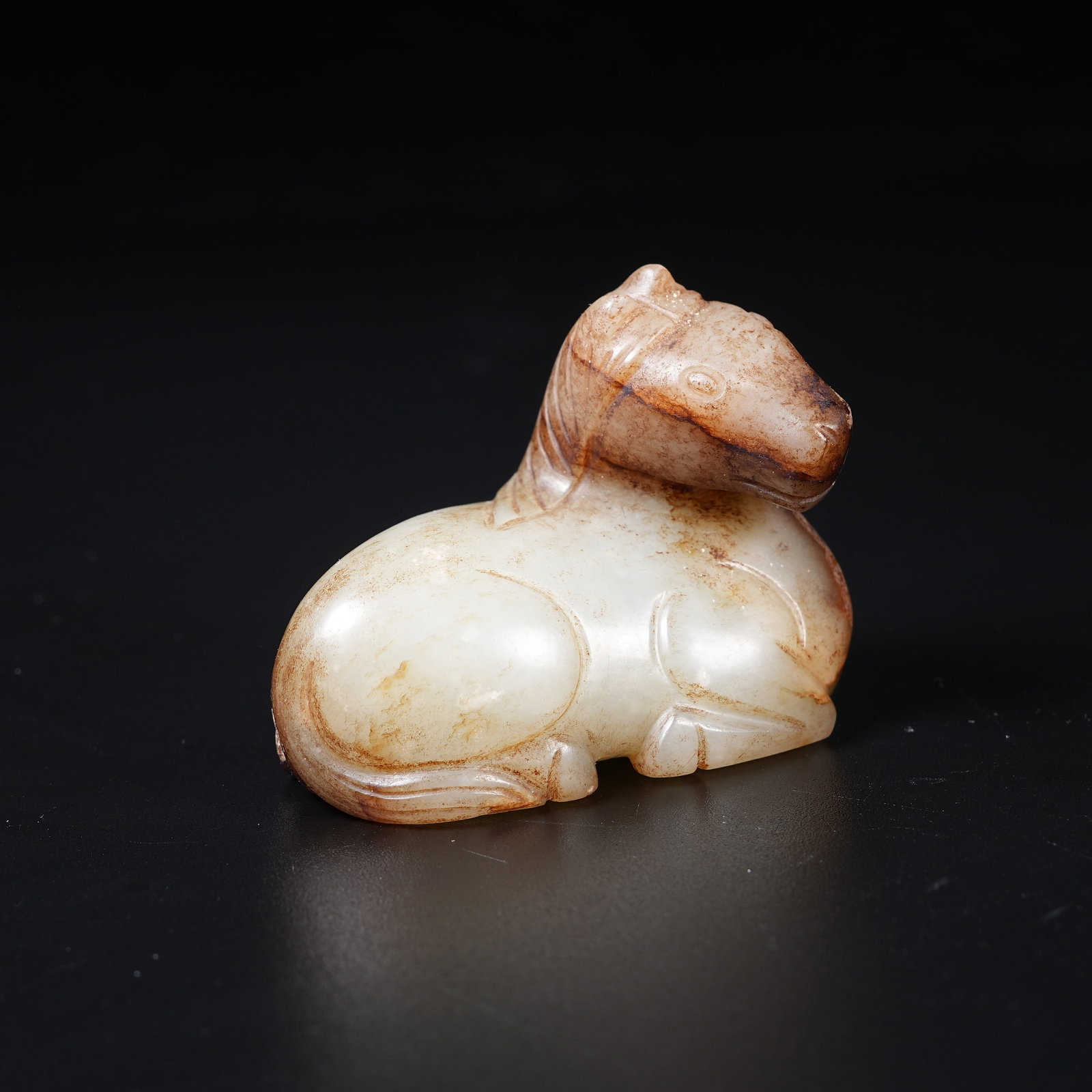 A MEDIEVAL JADE RECUMBENT HORSE ORNAMENT: Medieval Jade Recumbent Horse Ornament