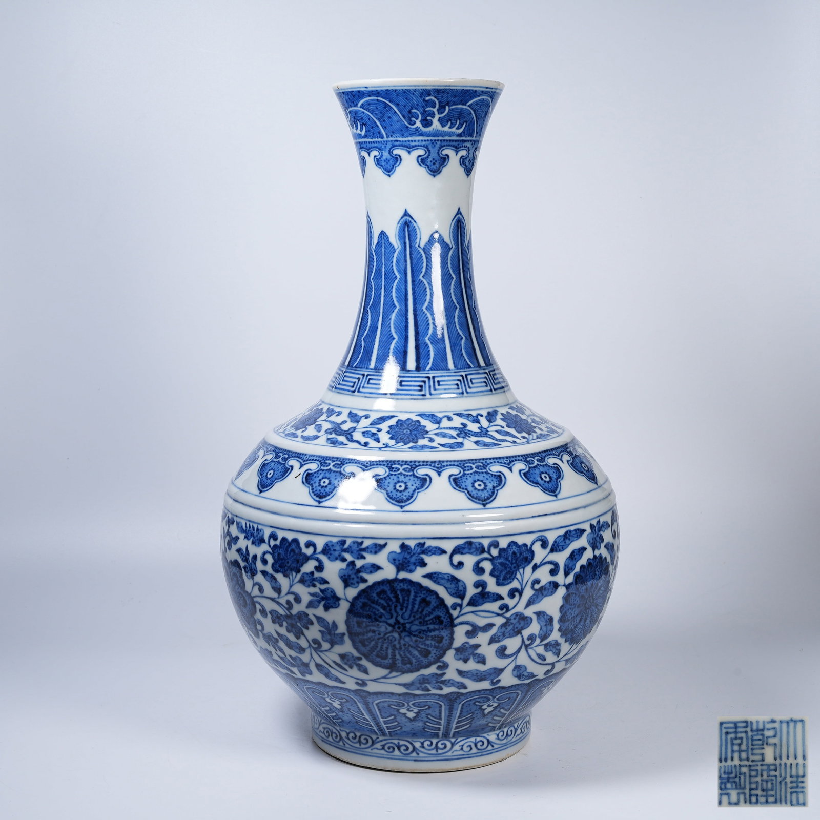 A BLUE AND WHITE ZUN WITH INTERLOCKING FLORAL SCROLLS: Blue and White Zun with Interlocking Floral Scrolls