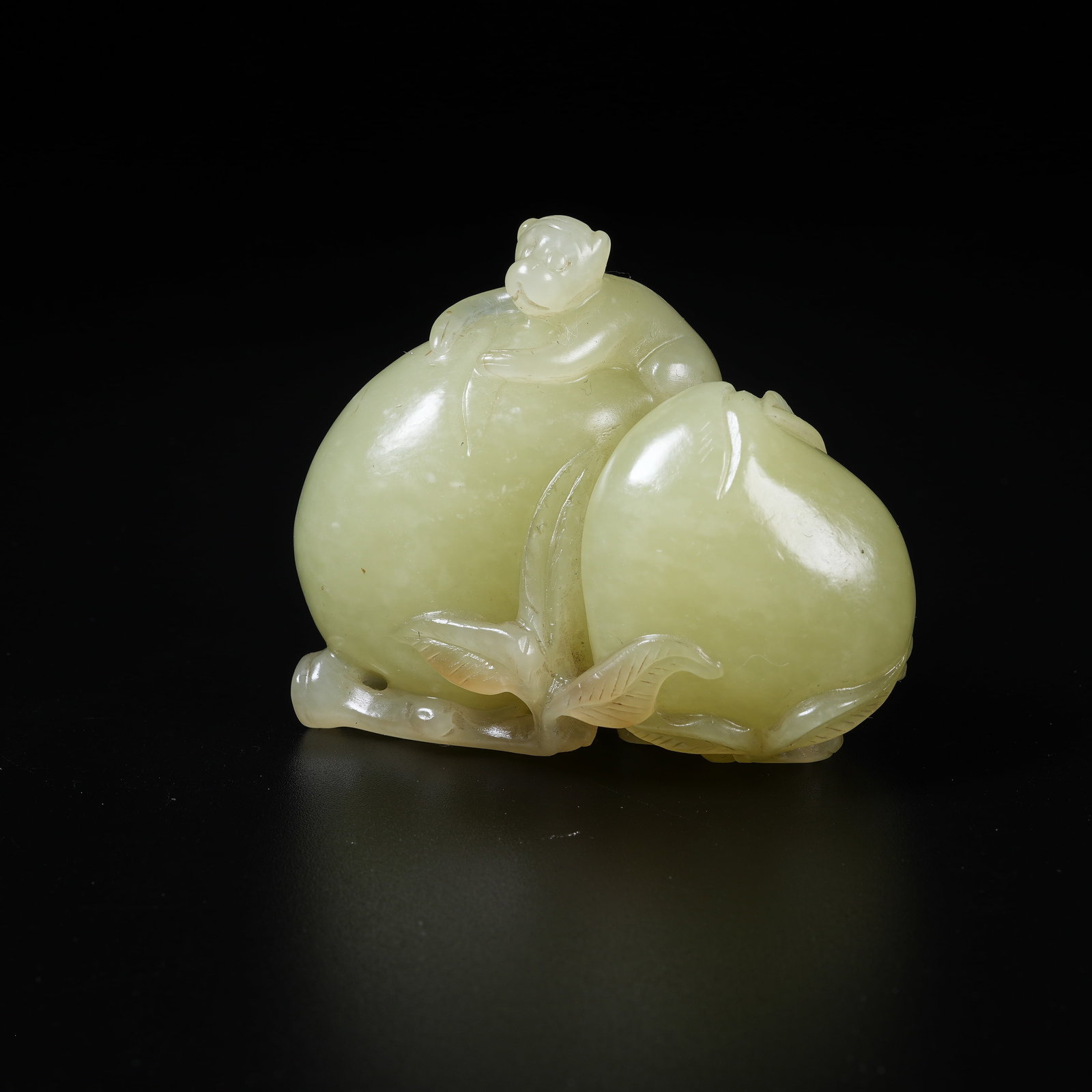 A YELLOW HETIAN JADE ORNAMENT OF SPIRITUAL MONKEY PRESENTING LONGEVITY: Yellow Hetian Jade Ornament of Spiritual Monkey Presenting Longevity