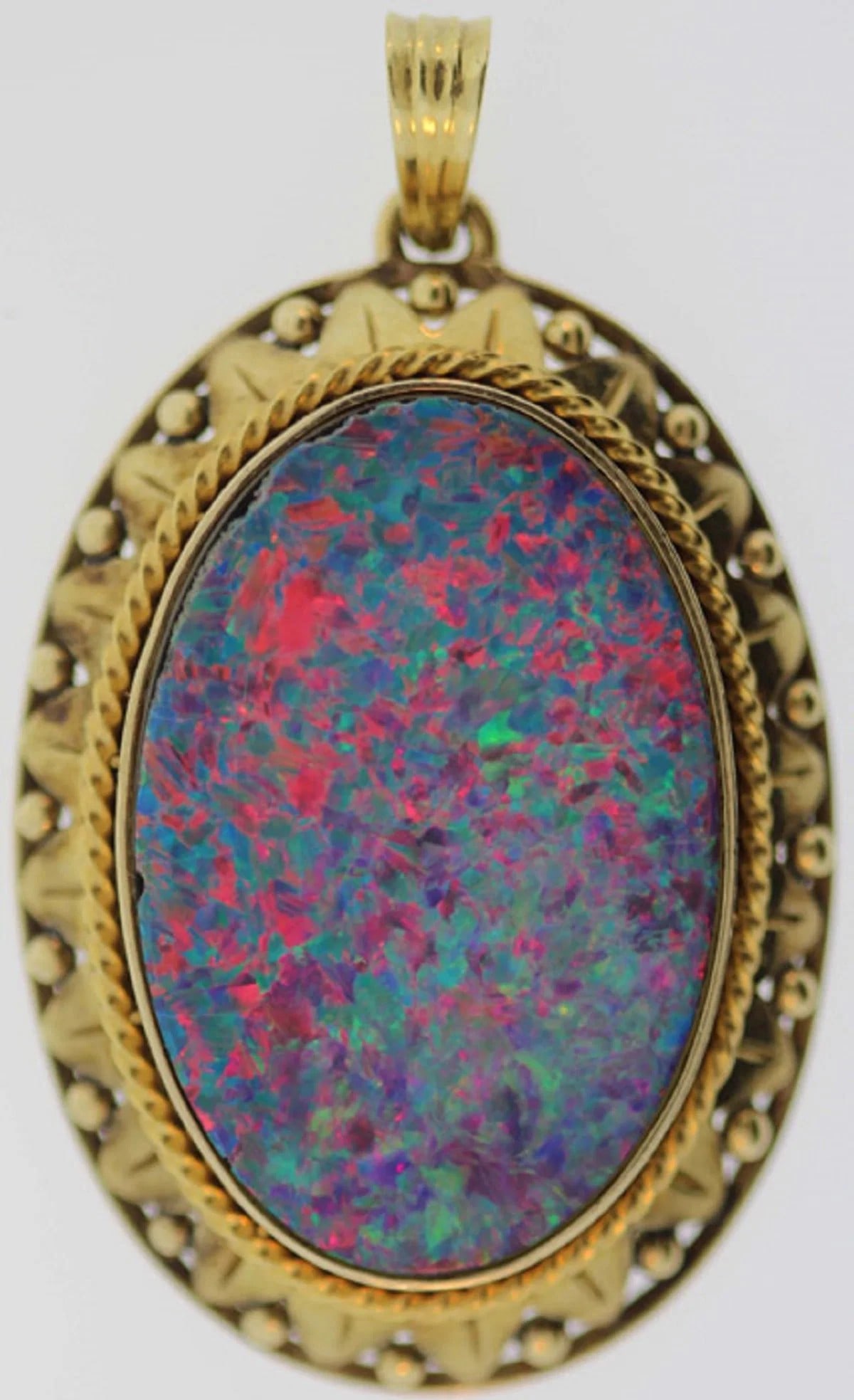 OPAL SET IN A BESPOKE 14CT YELLOW GOLD PENDANT: Opal set in a bespoke 14ct Yellow Gold Pendant