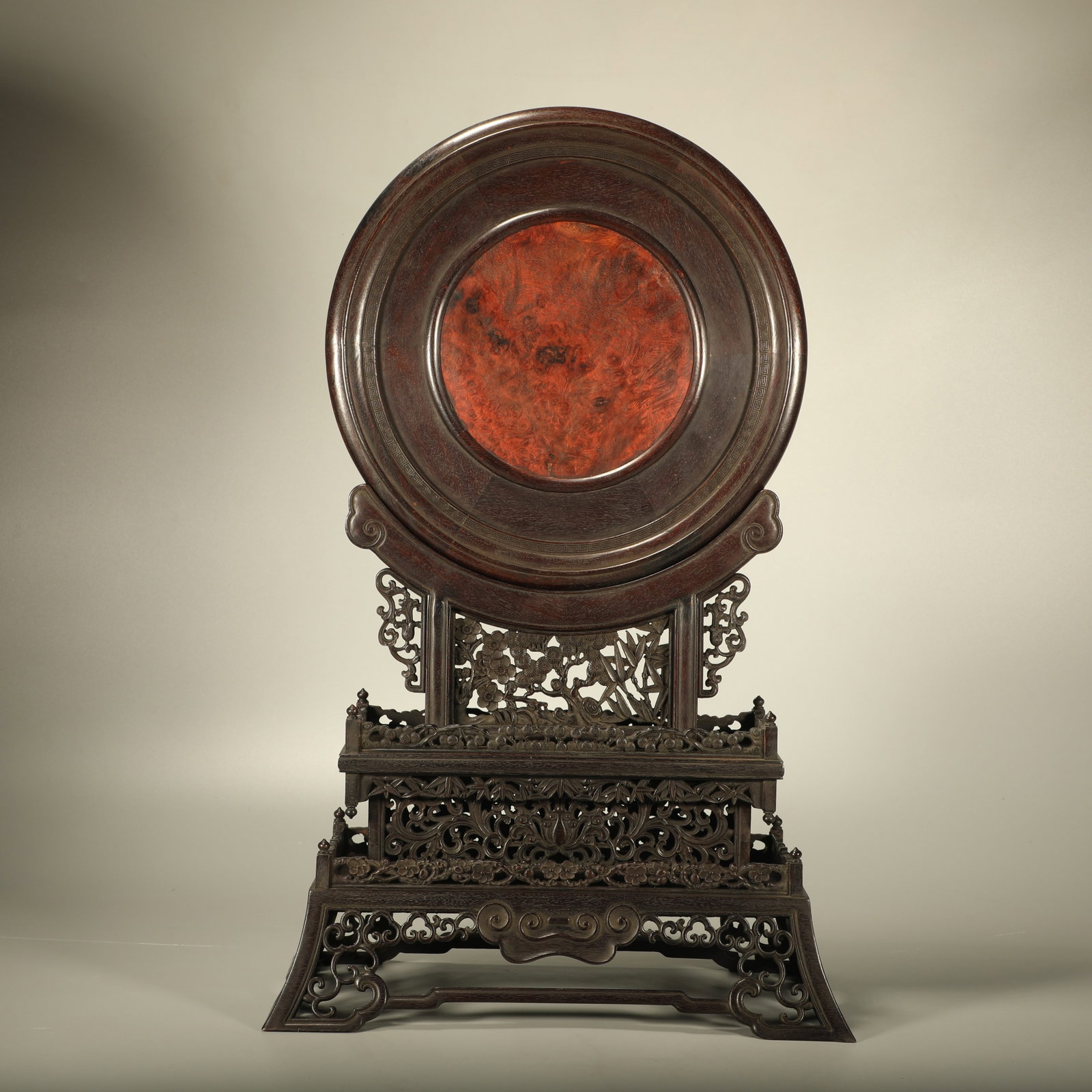 A RED SANDALWOOD STANDING SCREEN CARVED WITH PINE, BAMBOO AND PLUM INLAID WITH CHERRY WOOD: Red Sandalwood Standing Screen Carved with Pine, Bamboo and Plum Inlaid with Cherry Wood