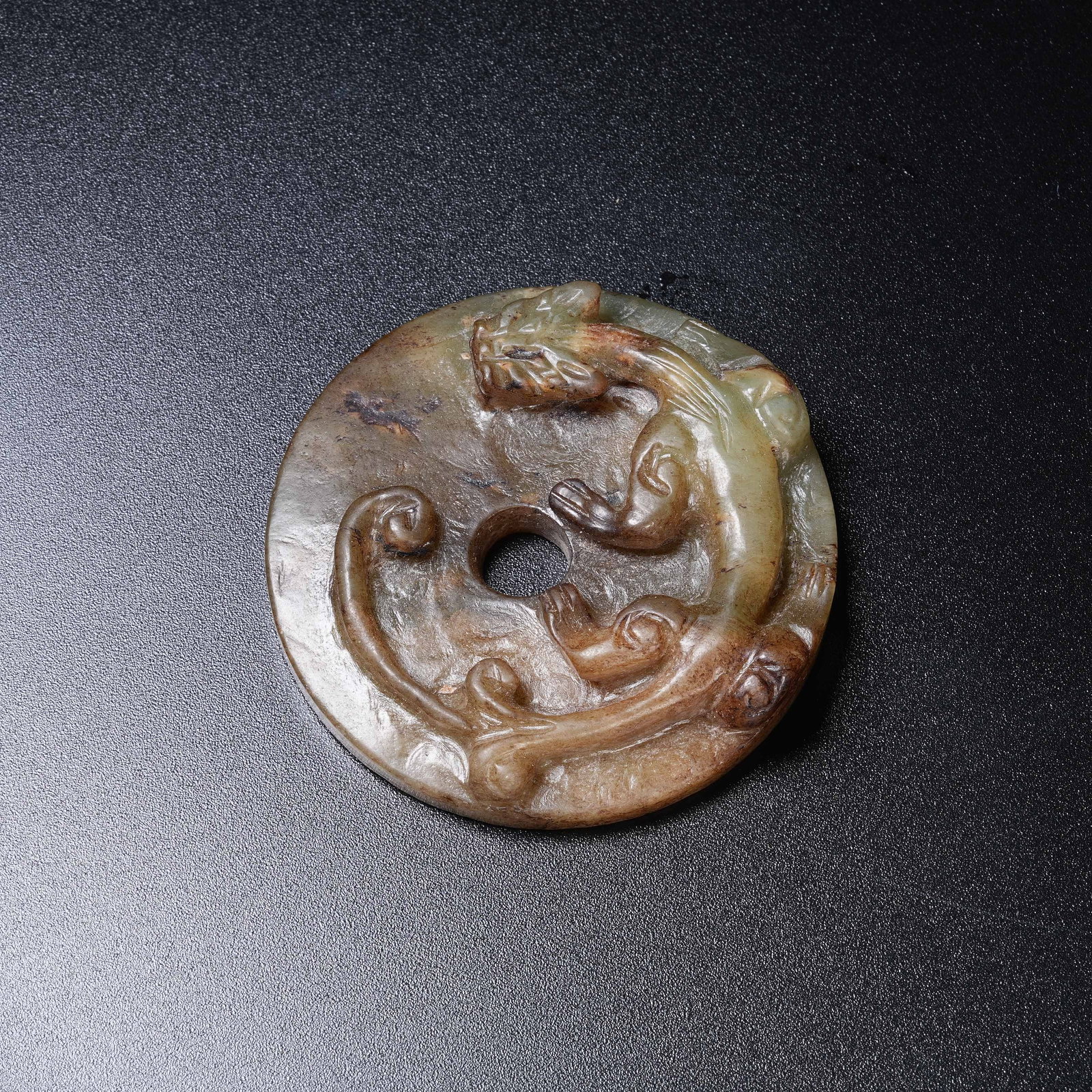 A ANCIENT JADE BI DISC WITH CHI DRAGON PATTERN: Ancient Jade Bi Disc with Chi Dragon Pattern