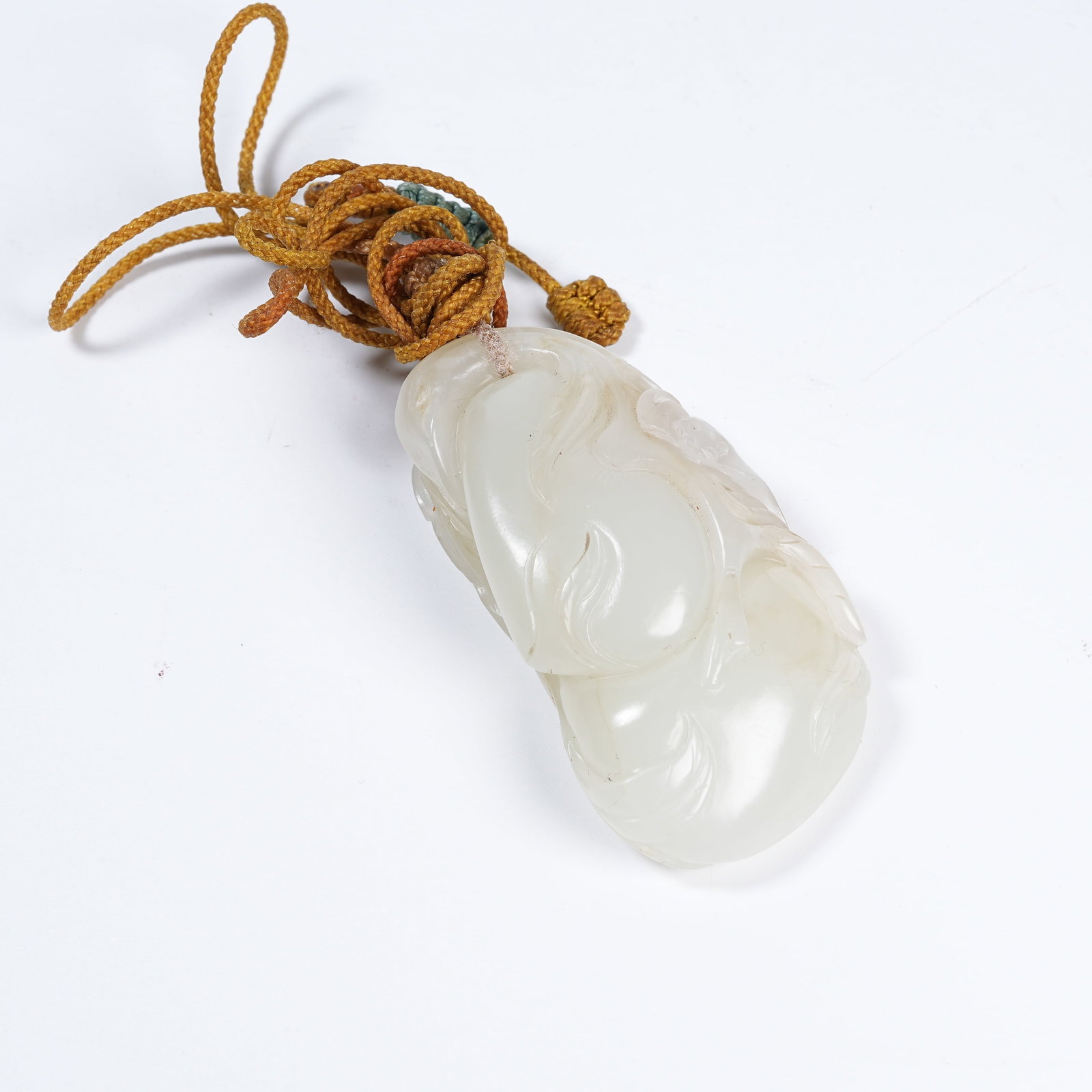 A HETIAN JADE LONGEVITY PEACH PENDANT: Hetian Jade Longevity Peach Pendant