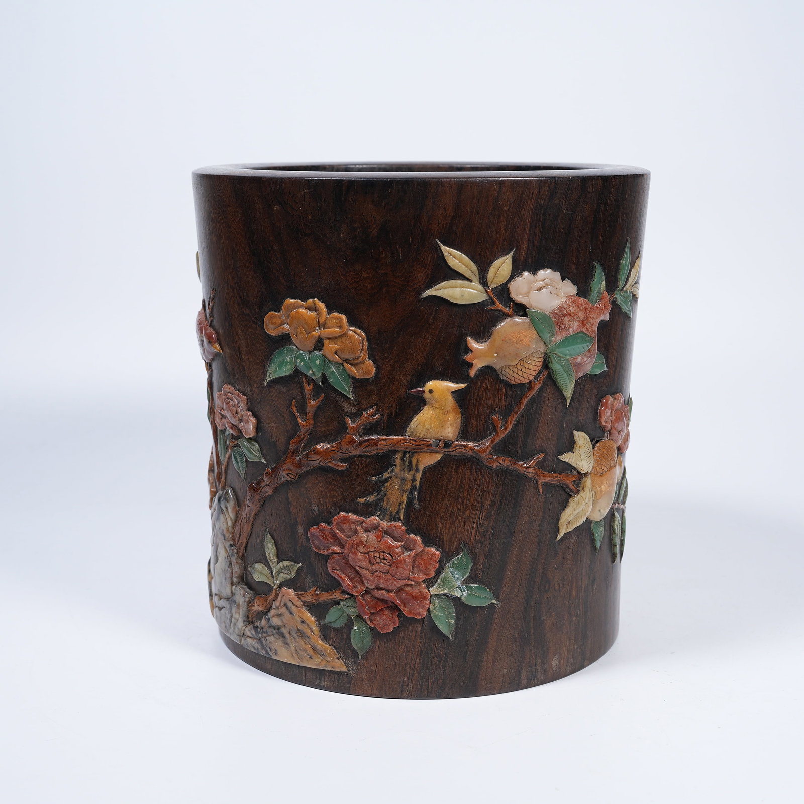 A HUANGHUALI BRUSH POT INLAID WITH VARIOUS PRECIOUS STONES CARVED WITH FLOWER AND BIRD MOTIFS: Huanghuali Brush Pot Inlaid with Various Precious Stones Carved with Flower and Bird Motifs