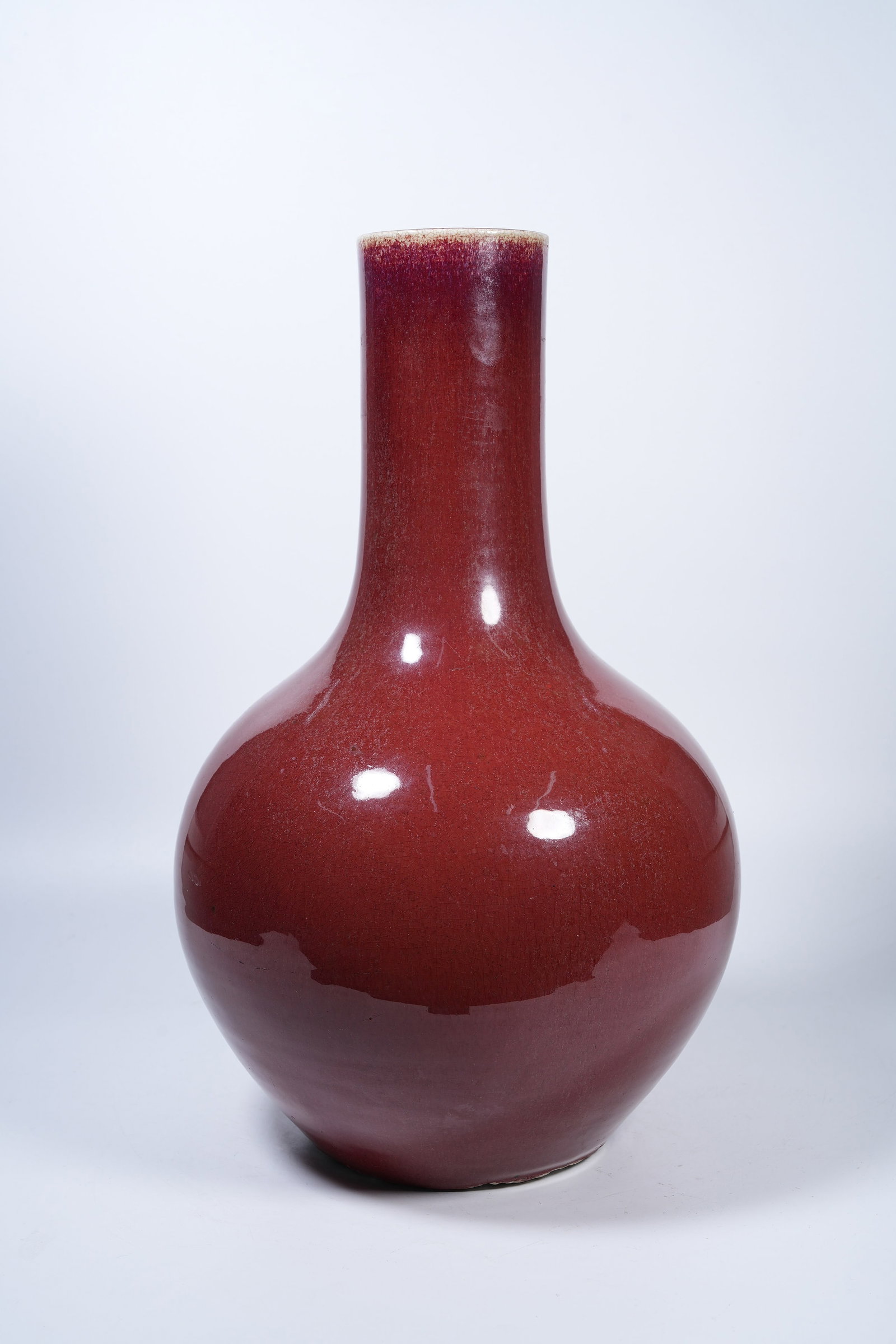 A SACRIFICIAL RED GLAZE CELESTIAL SPHERE VASE: Sacrificial Red Glaze Celestial Sphere Vase
