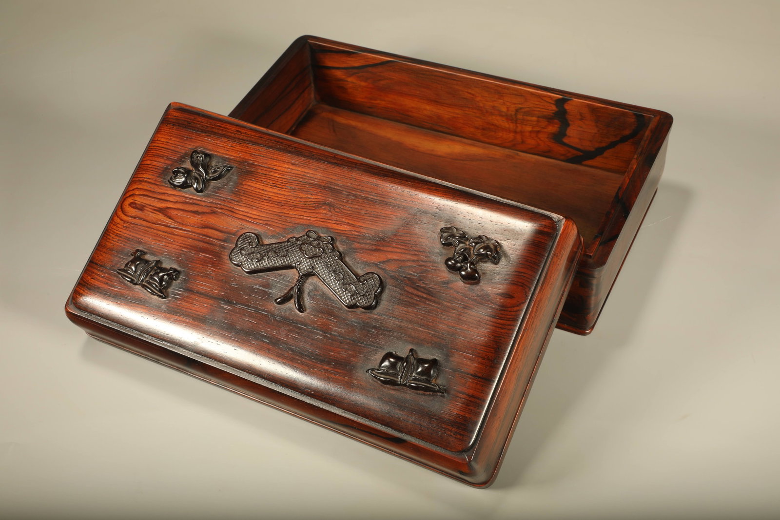 A PADAUK BOX INLAID WITH RED SANDALWOOD CARVED WITH AUSPICIOUS SURPLUS MOTIFS: Padauk Box Inlaid with Red Sandalwood Carved with Auspicious Surplus Motifs
