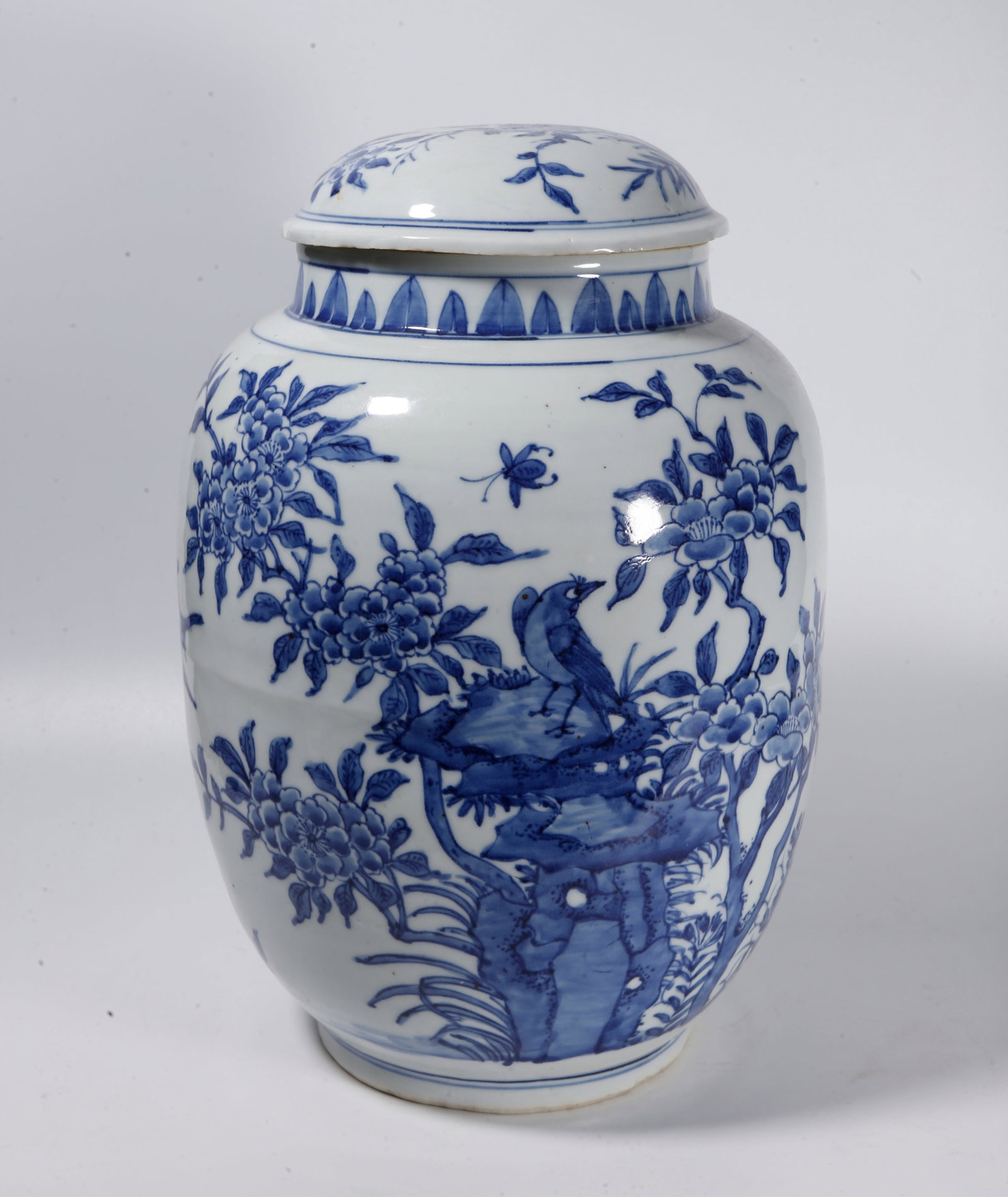 A BLUE AND WHITE COVERED JAR WITH FLOWER AND BIRD PATTERNS: Blue and White Covered Jar with Flower and Bird Patterns