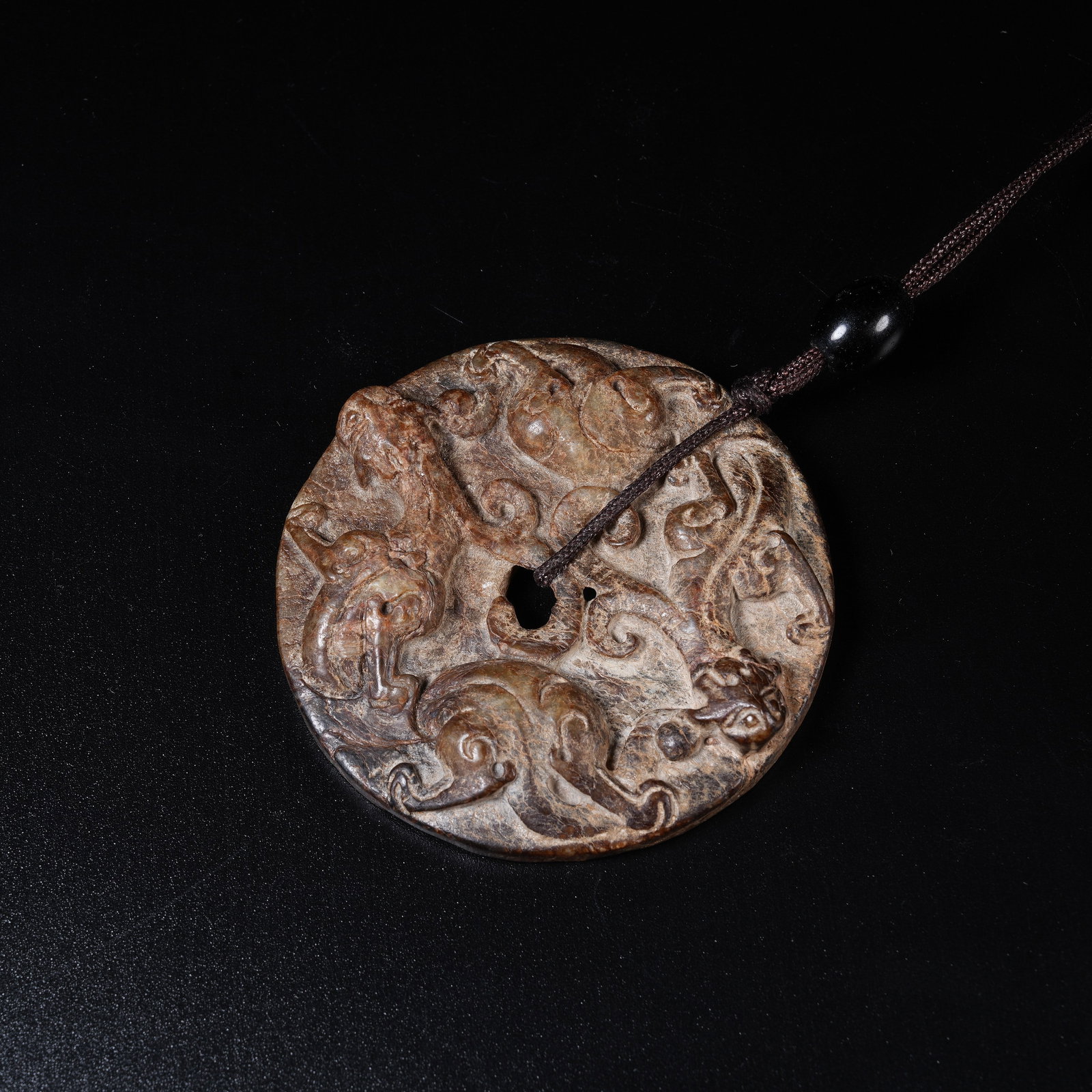 A ANCIENT JADE BI DISC WITH CHI DRAGON PATTERN: Ancient Jade Bi Disc with Chi Dragon Pattern