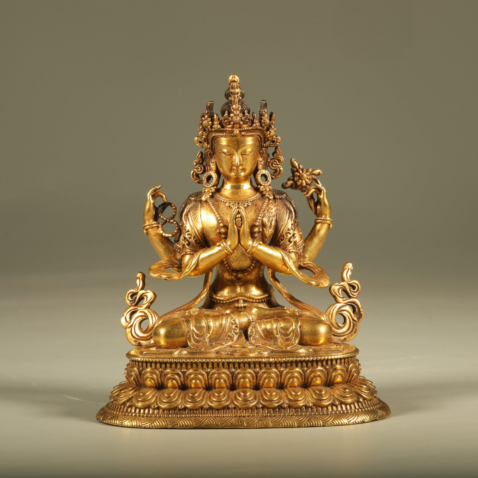 A GILT BRONZE STATUE OF FOUR-ARMED GUANYIN: Gilt Bronze Statue of Four-Armed Guanyin