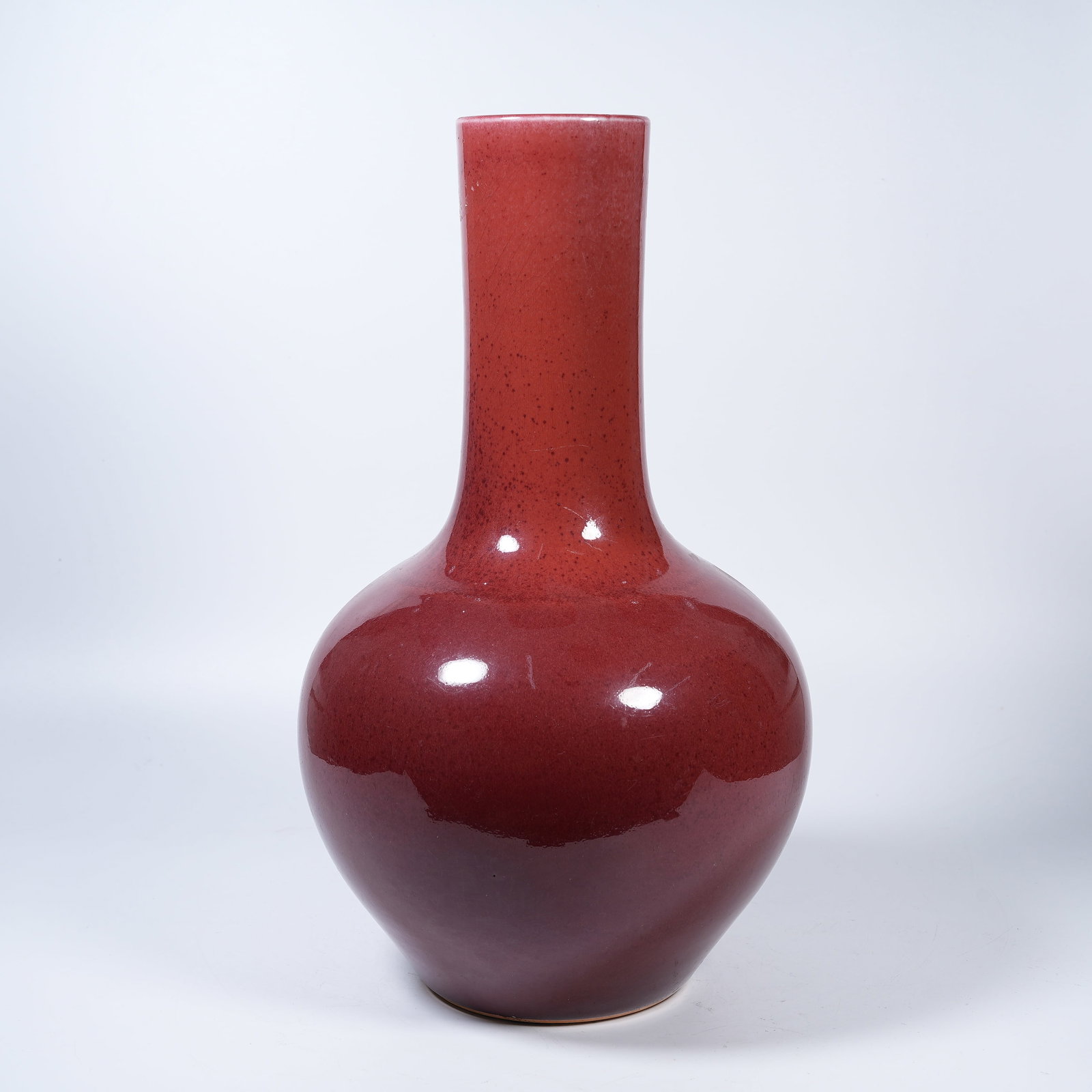 A SACRIFICIAL RED GLAZE CELESTIAL SPHERE VASE: Sacrificial Red Glaze Celestial Sphere Vase