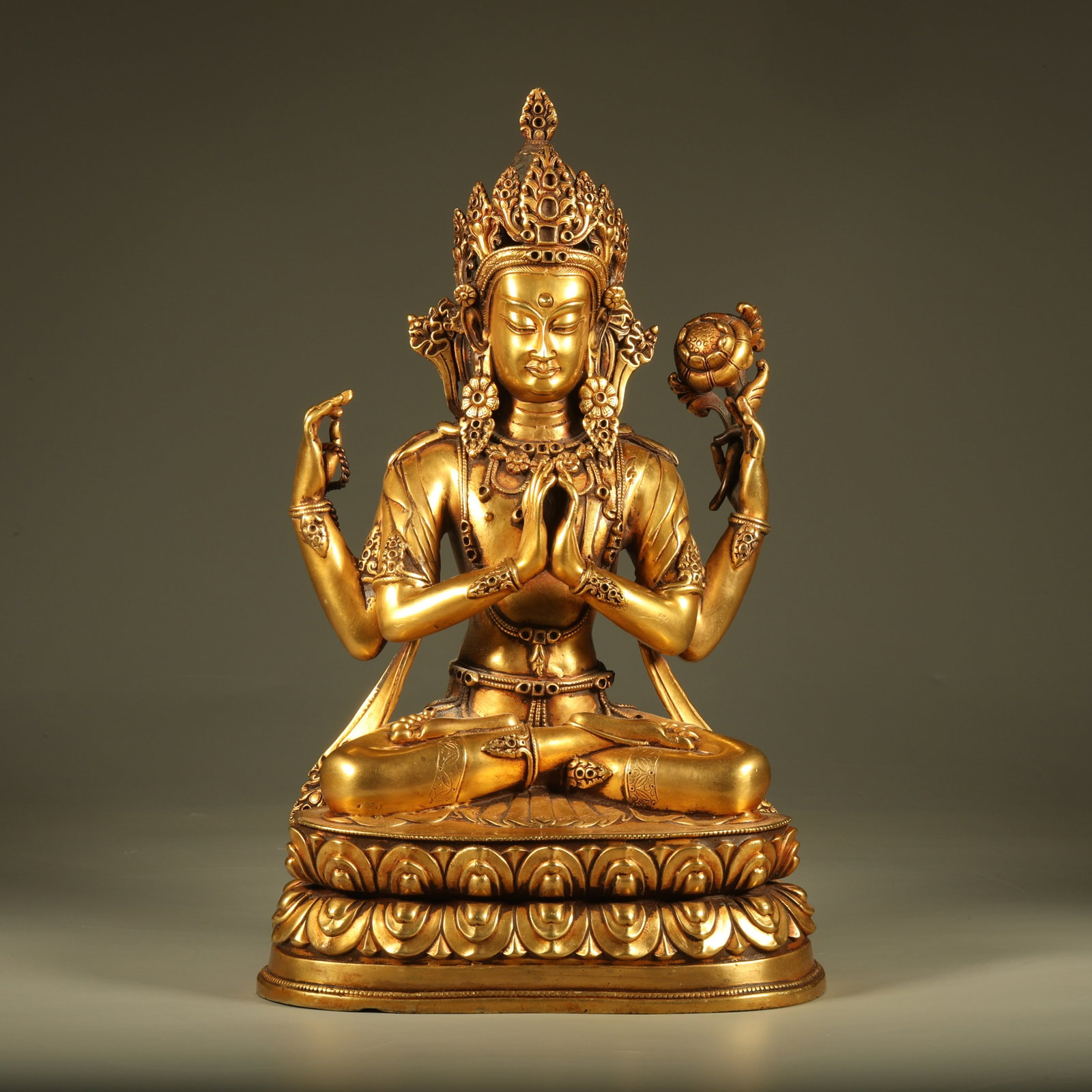 A GILT BRONZE STATUE OF FOUR-ARMED GUANYIN: Gilt Bronze Statue of Four-Armed Guanyin