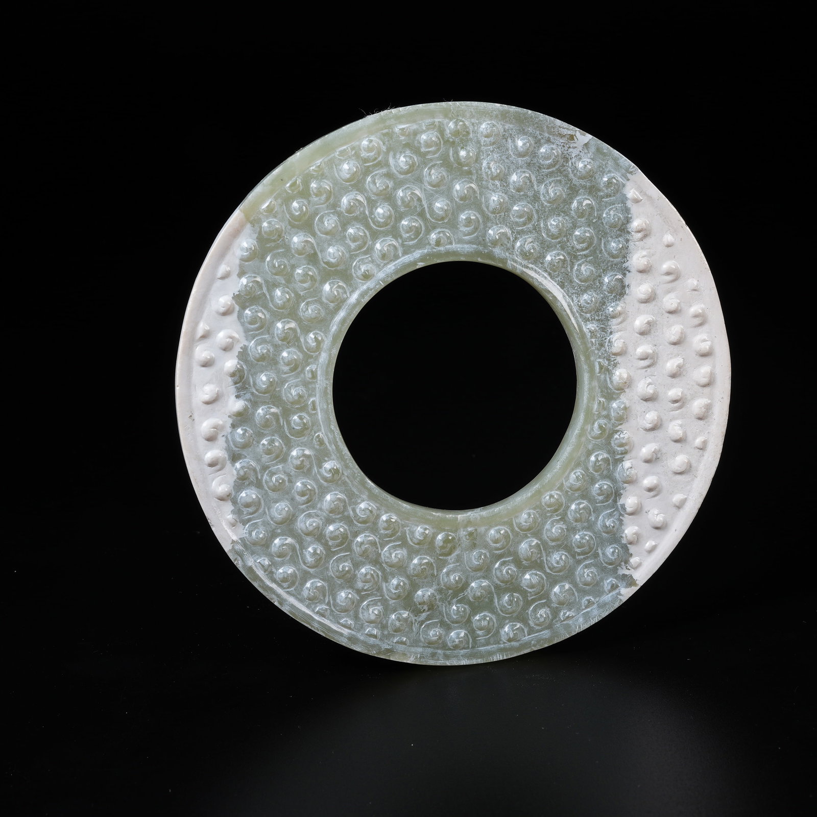 A ANCIENT JADE BI DISC WITH HOOKED CLOUD PATTERN: Ancient Jade Bi Disc with Hooked Cloud Pattern