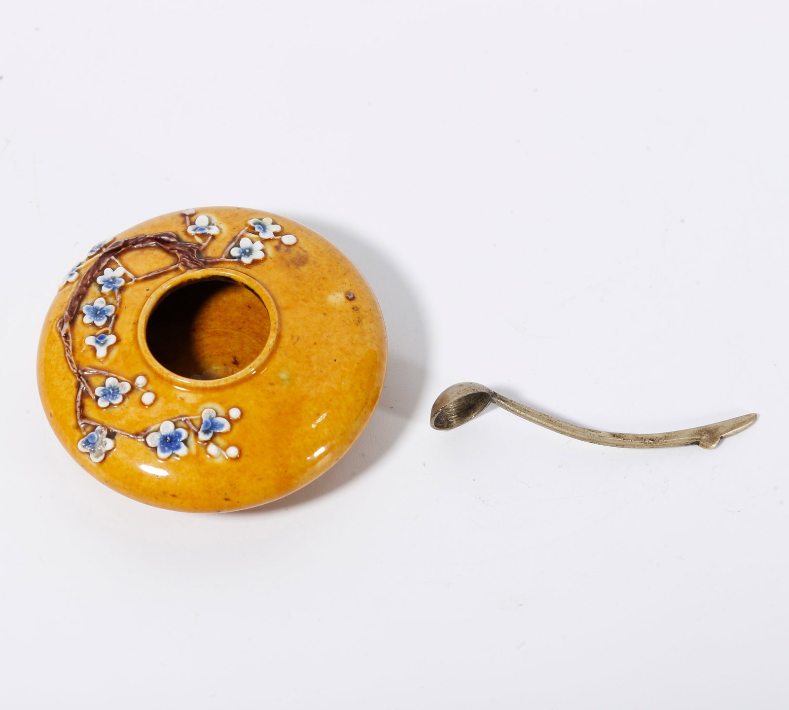 A YELLOW-GROUND BLUE AND WHITE WATER JAR WITH PLUM BLOSSOM MOTIFS: Yellow-ground blue and white water jar with plum blossom motifs