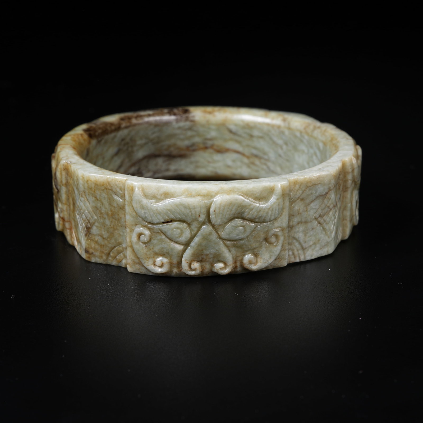 A ANCIENT JADE BI RING WITH BEAST MASK MOTIFS: Ancient Jade Bi Ring with Beast Mask Motifs