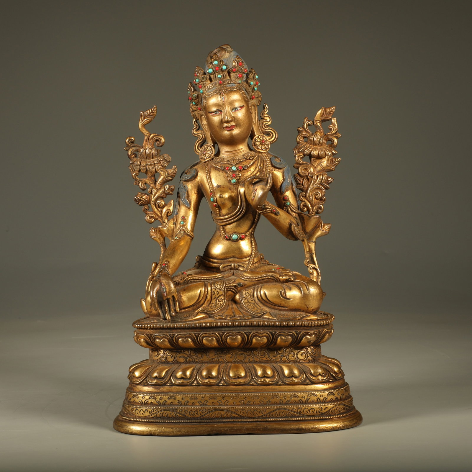 A GEM-INLAID GILT BRONZE STATUE OF GREEN TARA (1 of 8)
