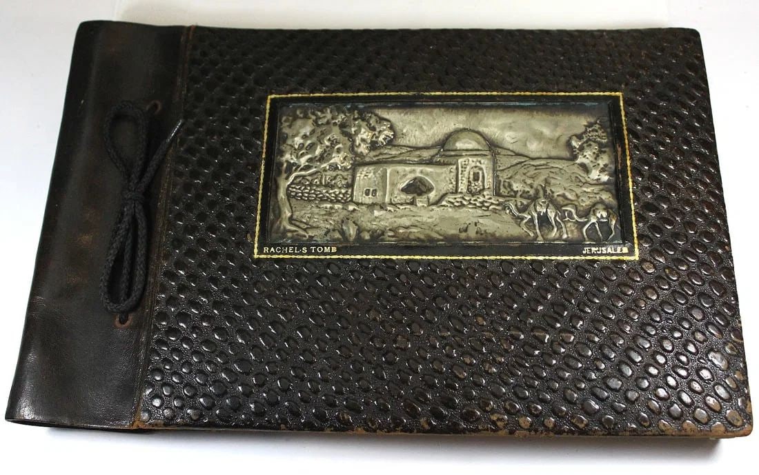 WWI - NEW ZEALAND SERVICEMAN'S SOUVENIR PHOTO ALBUM OF THE 'HOLY LAND' CIRCA 1919: 78 photos many with the personal annotations of "Leonard George Winnicott." The leather cover has a pressed metal insert of 'Rachel's Tomb, Jerusalem'SizeAlbum measures 31x20cmsMediumMilitary & Wartim