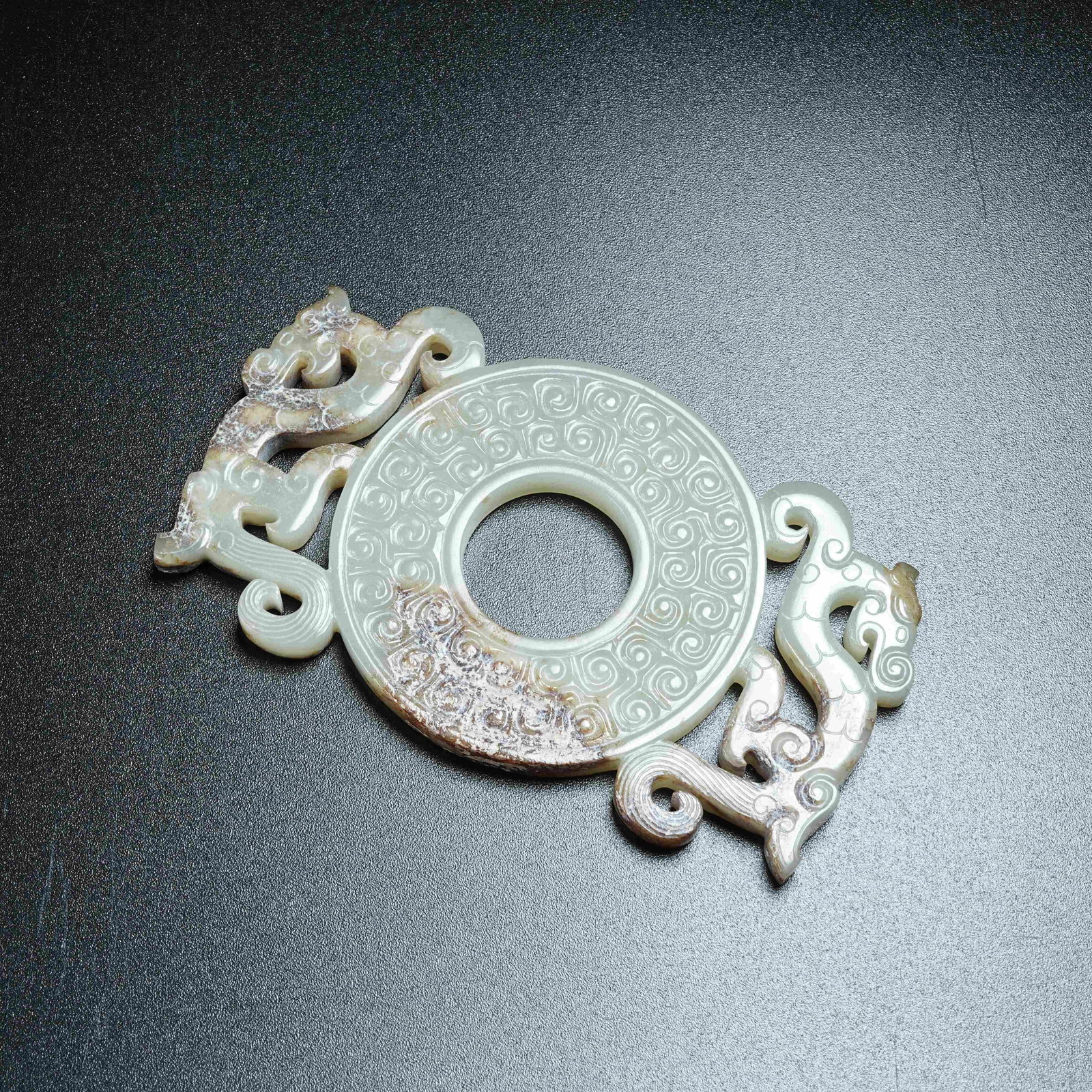 A ANCIENT JADE OUTLINED BI DISC WITH CHI DRAGON PATTERNS: Ancient Jade Outlined Bi Disc with Chi Dragon Patterns