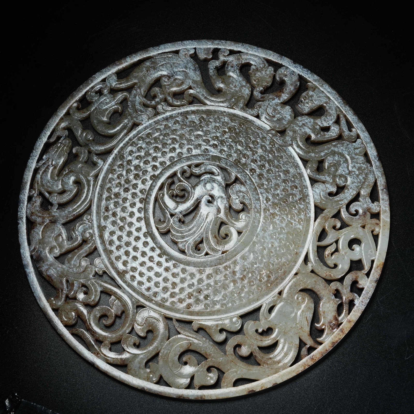 A ARCHAIC JADE BI DISC WITH DRAGON AND PHOENIX PATTERN: Archaic Jade Bi Disc with Dragon and Phoenix Pattern