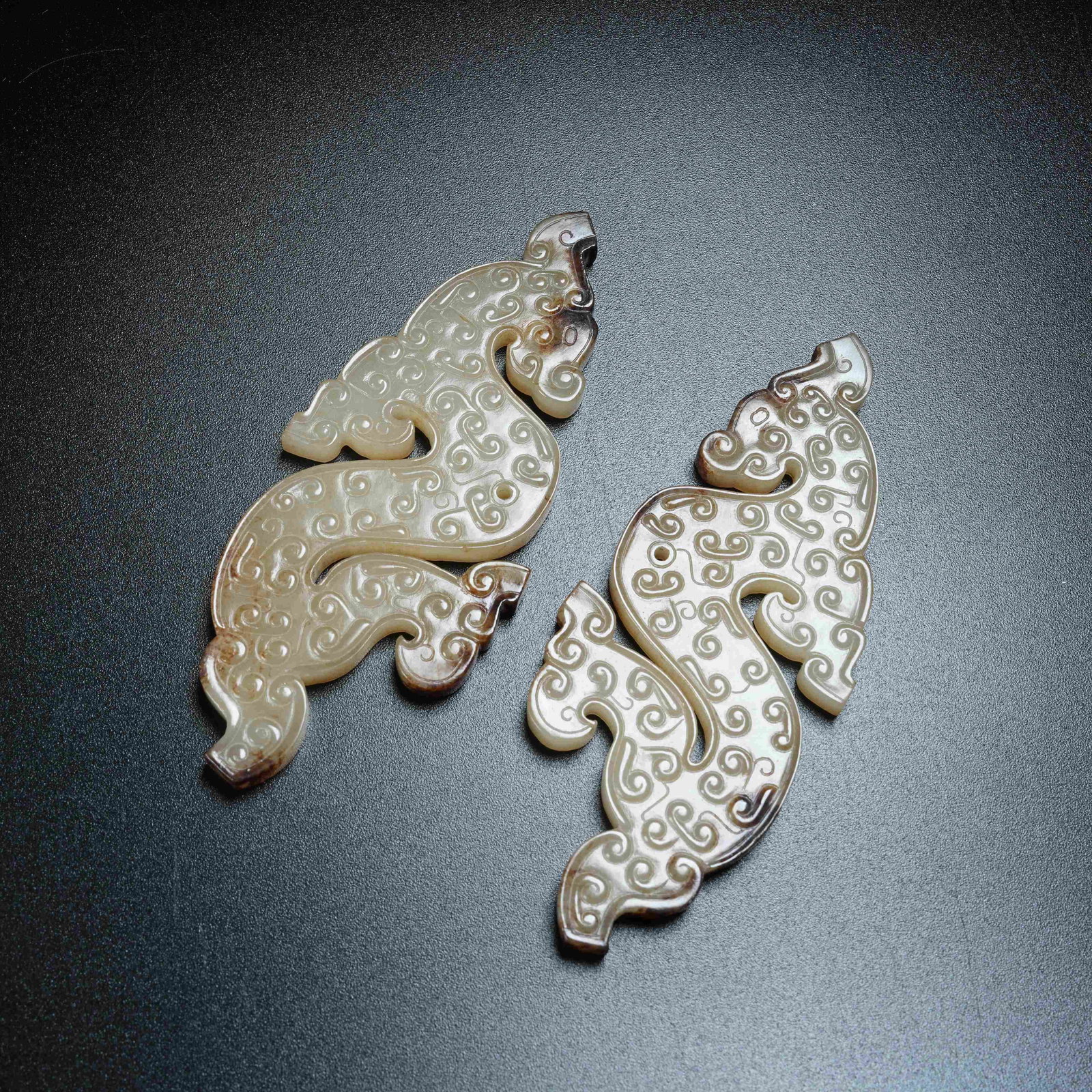 A SET OF ANCIENT JADE S-SHAPED DRAGON PENDANTS: Set of Ancient Jade S-shaped Dragon Pendants