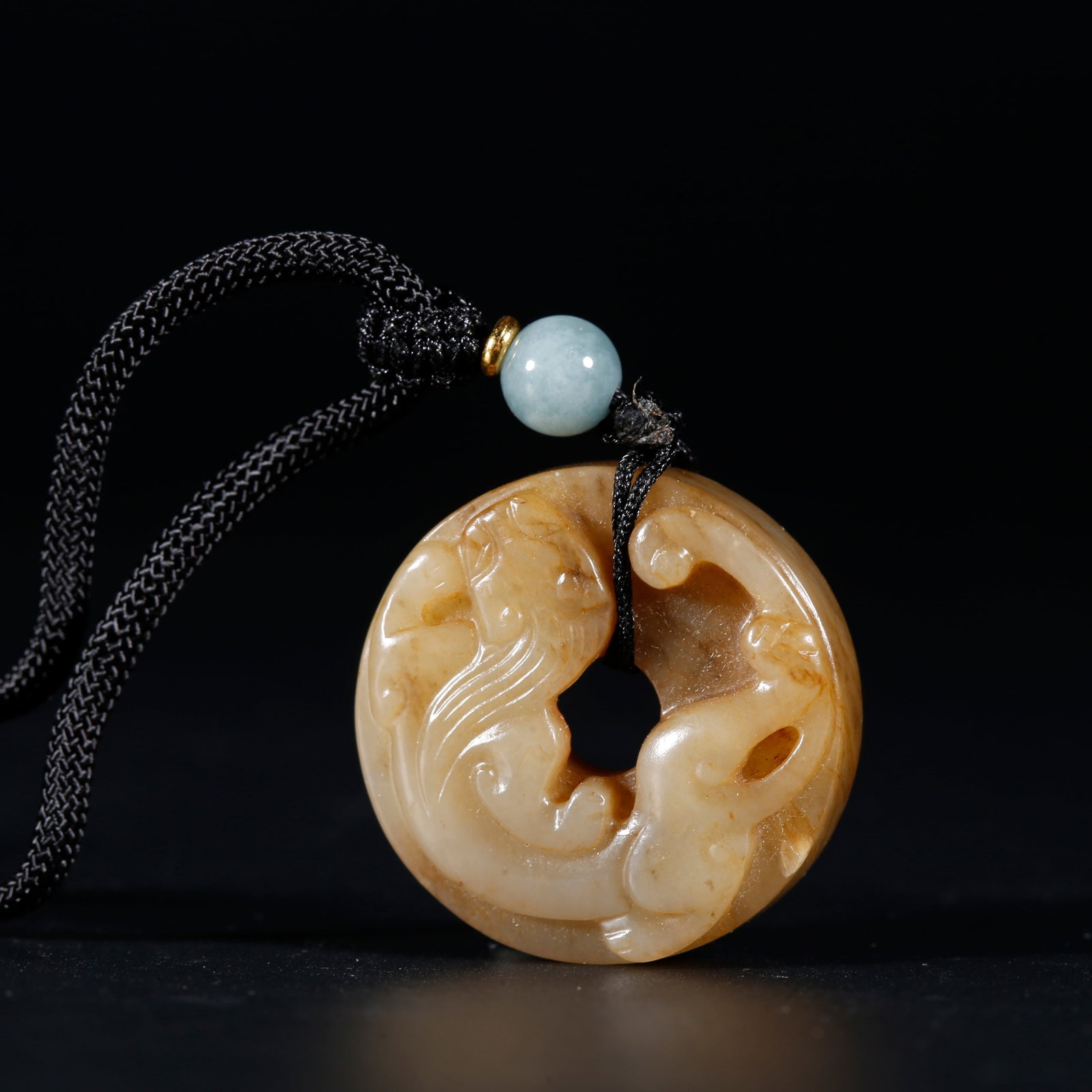 A HETIAN JADE SMALL LOOPED BI DISC WITH DRAGON PATTERN: Hetian Jade Small Looped Bi Disc with Dragon Pattern