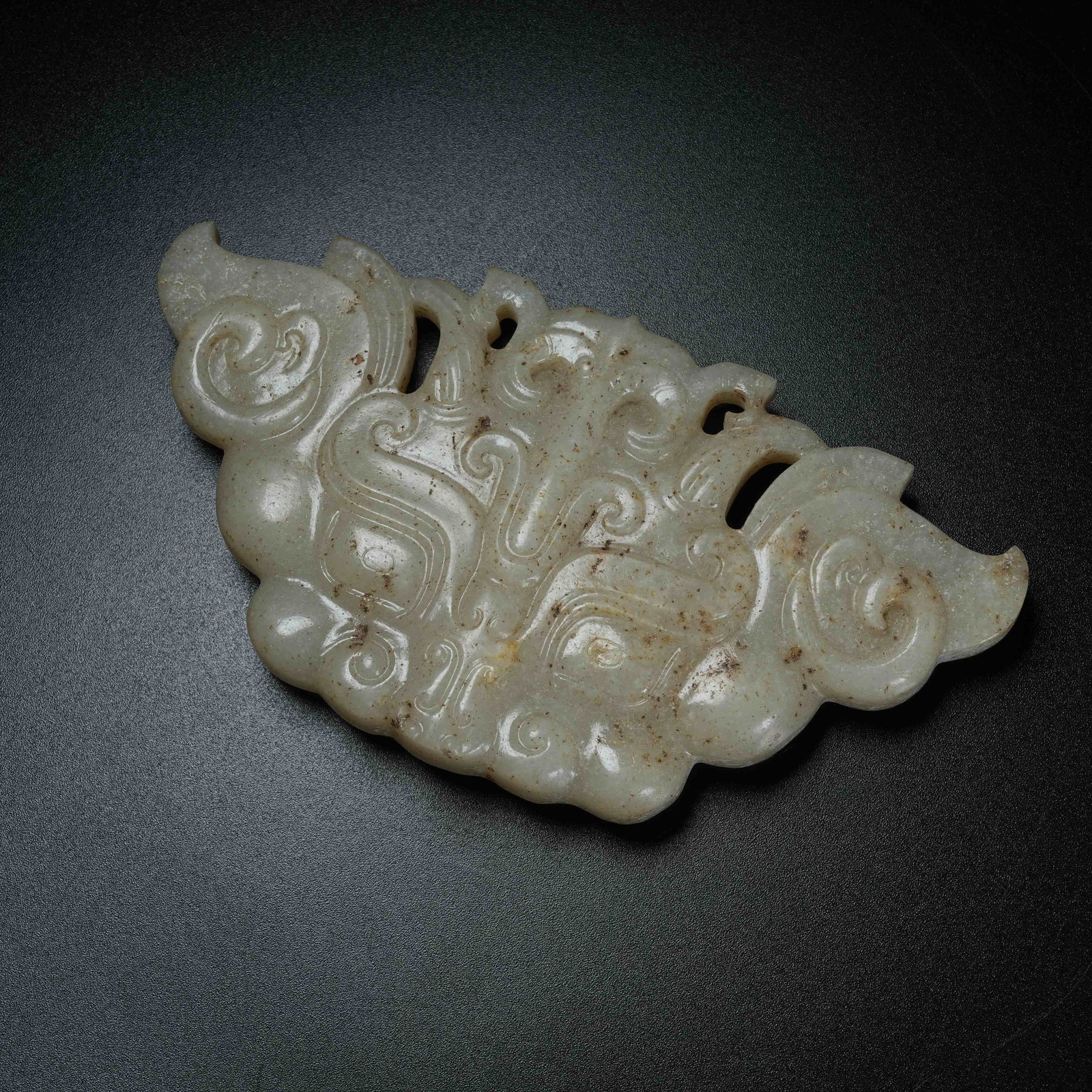 A ARCHAIC JADE BELT ORNAMENT WITH BEAST MASK PATTERN: Archaic Jade Belt Ornament with Beast Mask Pattern