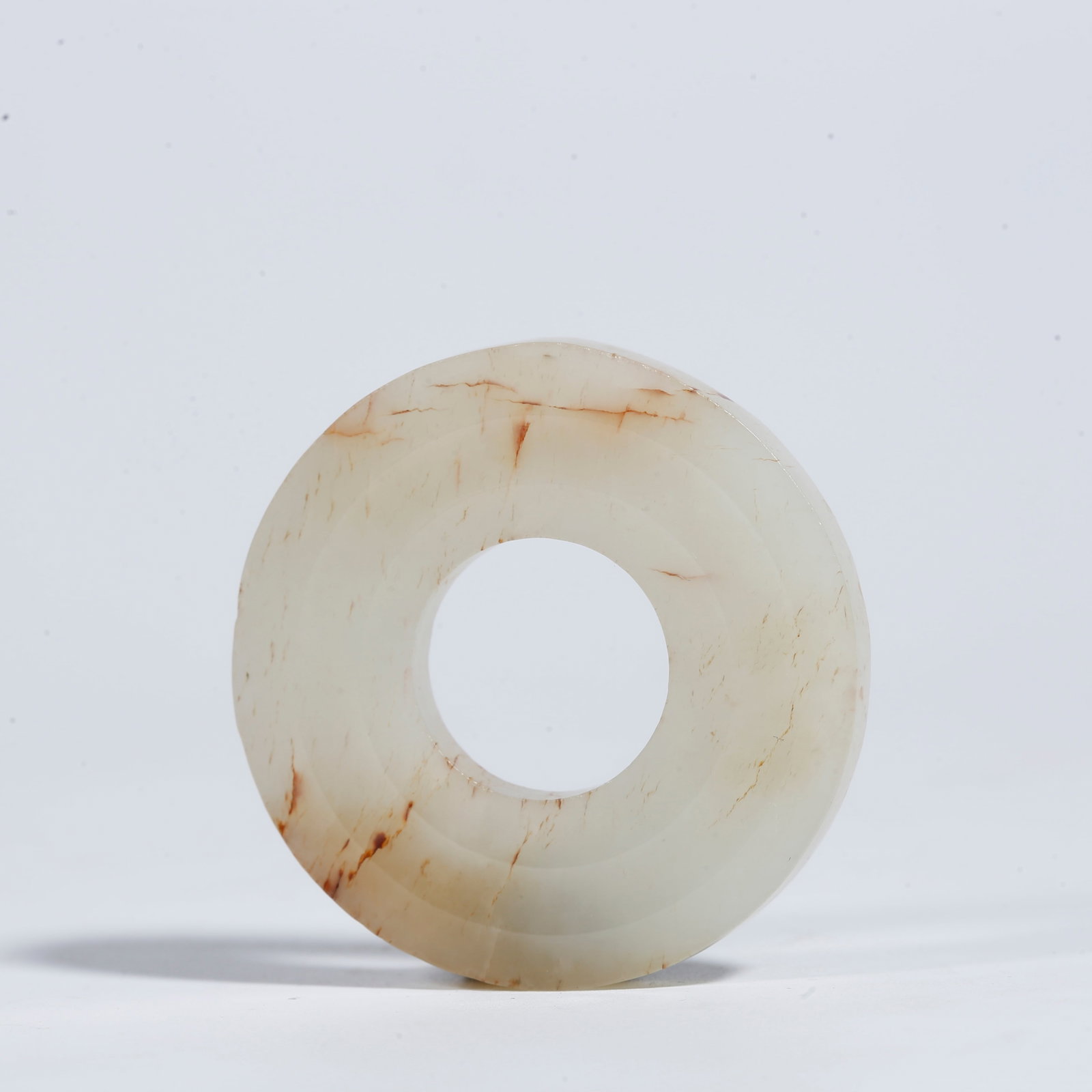 A SMALL HETIAN JADE BI DISC WITH SUSPENSION HOLE: Small Hetian Jade Bi Disc with Suspension Hole