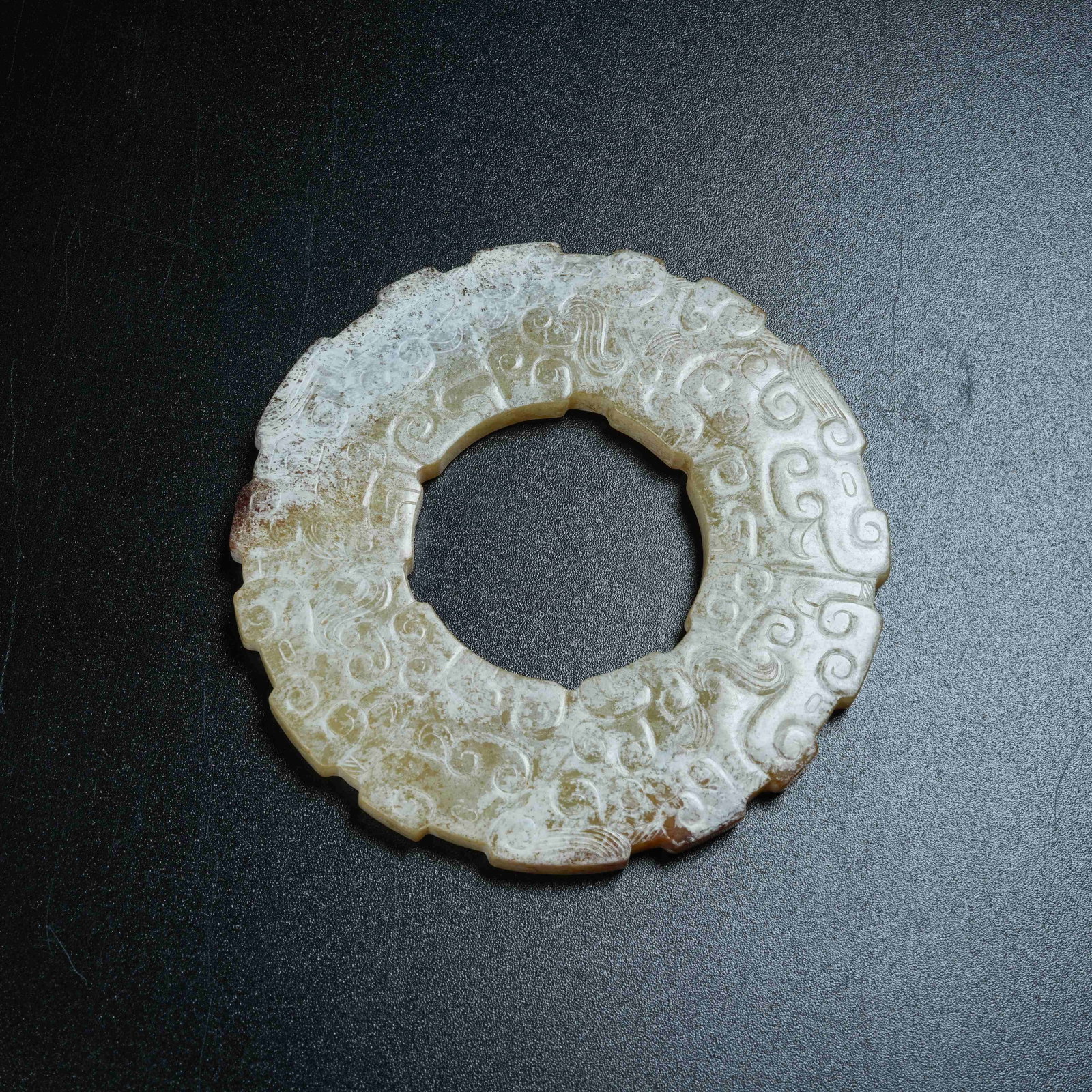A ANCIENT JADE BI DISC WITH HOOKED CLOUD PATTERNS: Ancient Jade Bi Disc with Hooked Cloud Patterns
