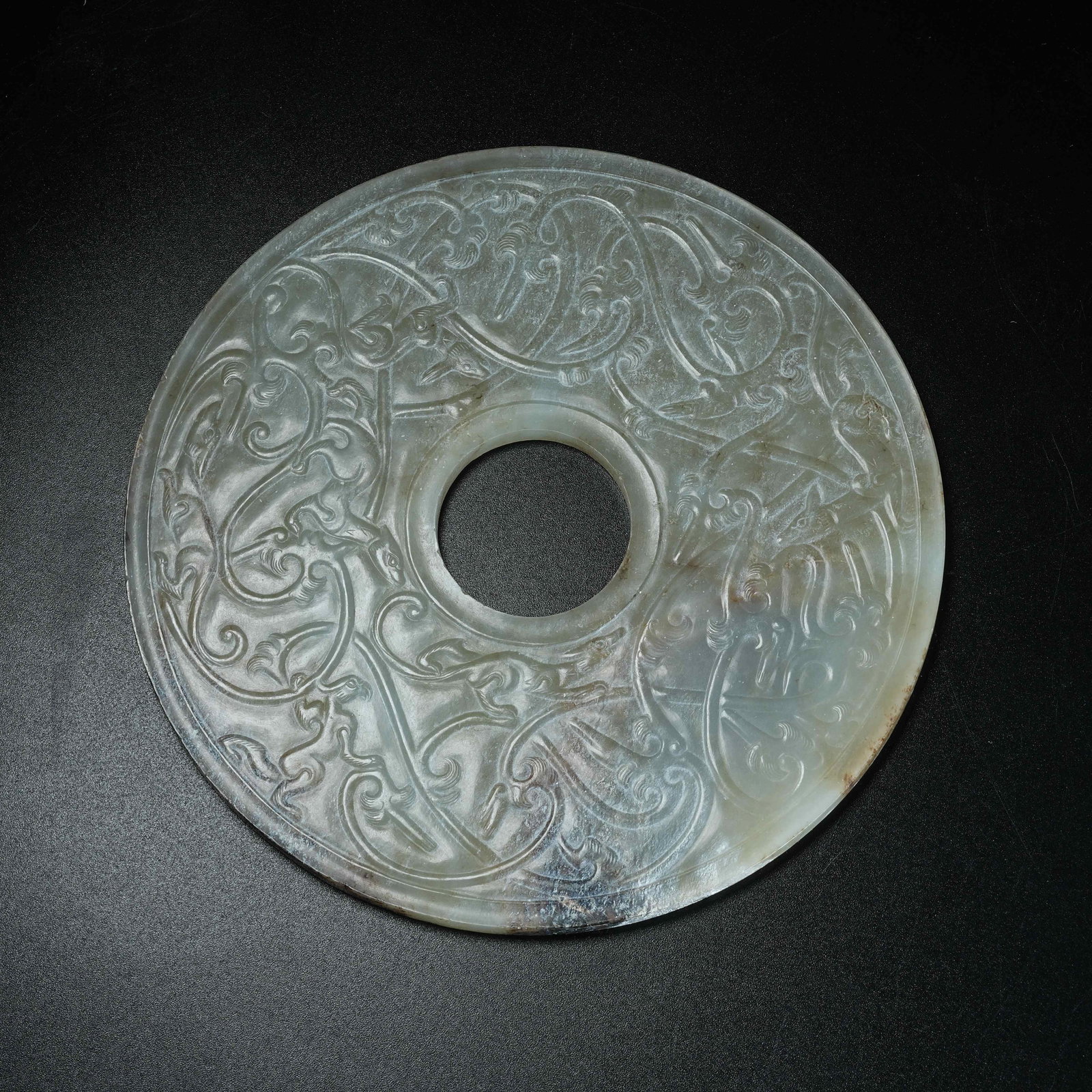 A ARCHAIC JADE BI DISC WITH BEAST PATTERN: Archaic Jade Bi Disc with Beast Pattern