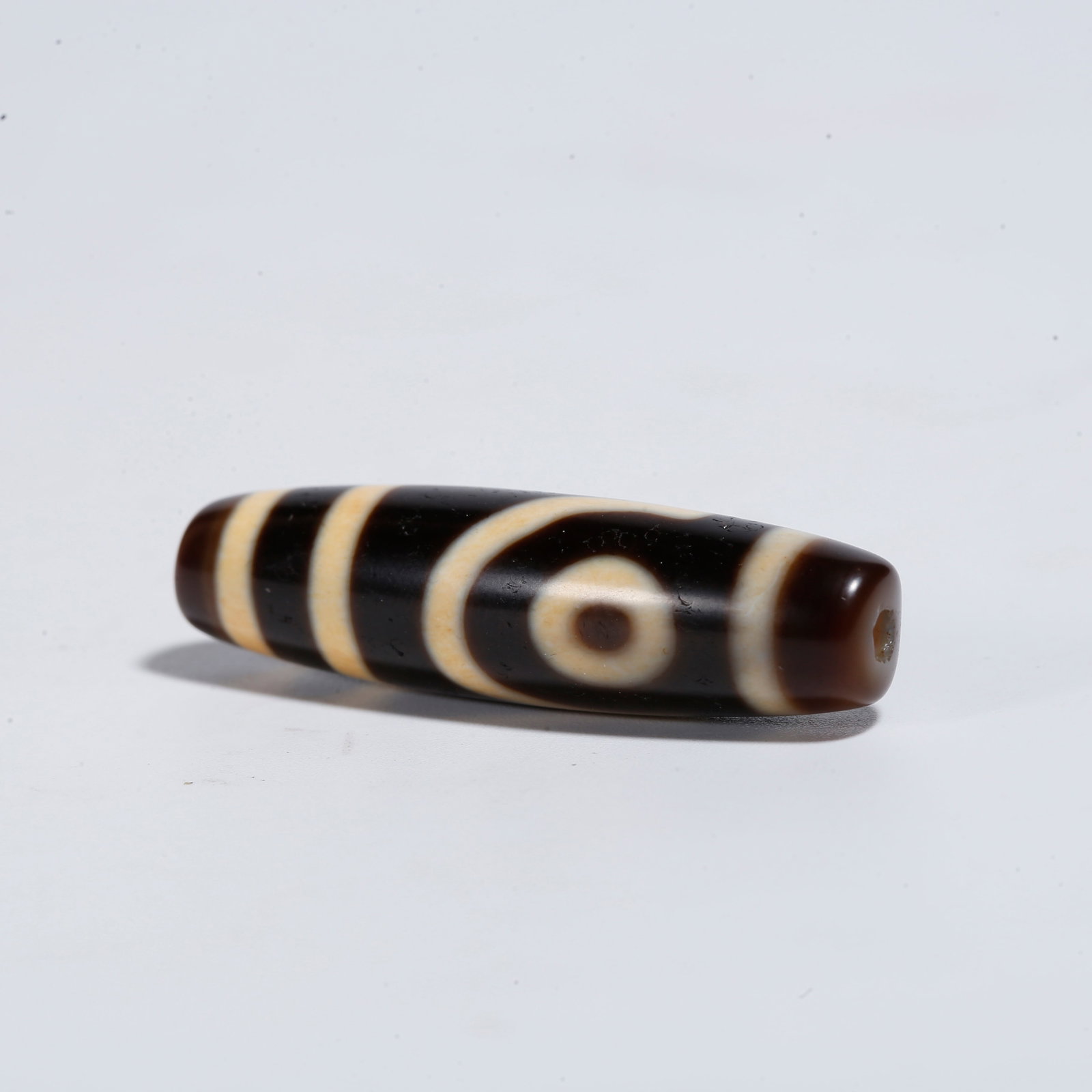A TWO-EYED DZI BEAD: Two-Eyed Dzi Bead