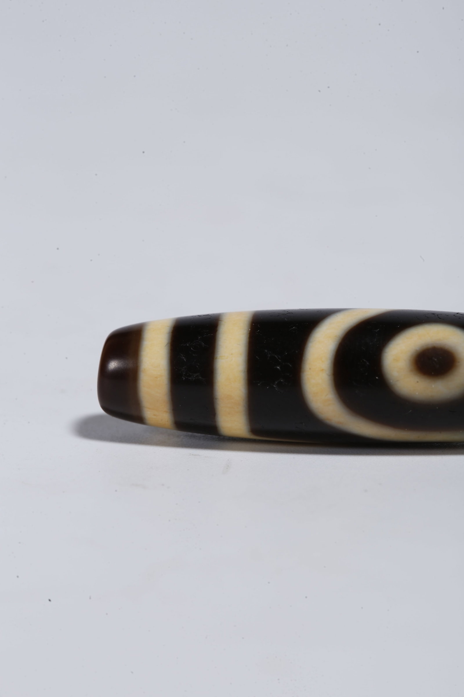 A TWO-EYED DZI BEAD - 6