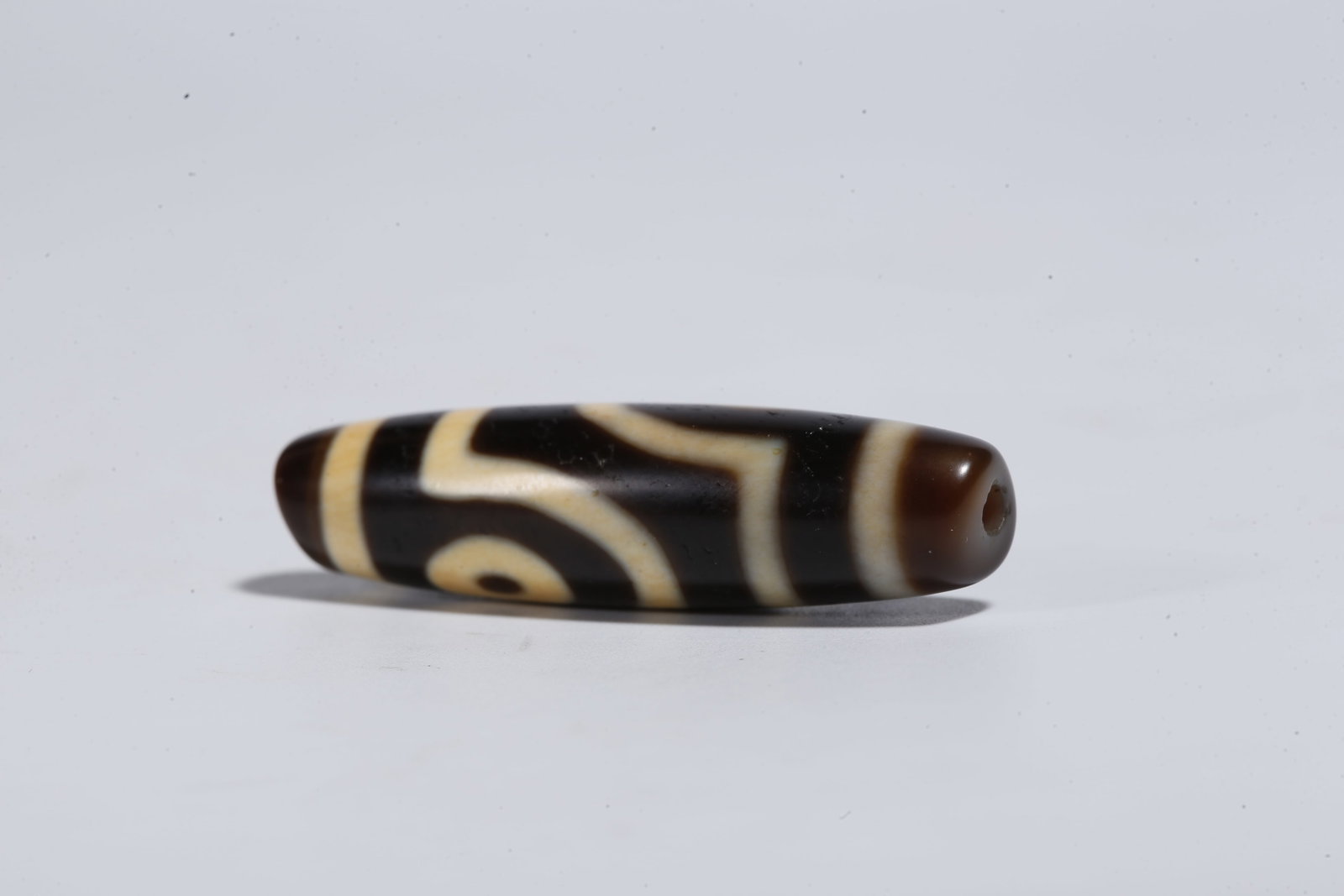 A TWO-EYED DZI BEAD - 8