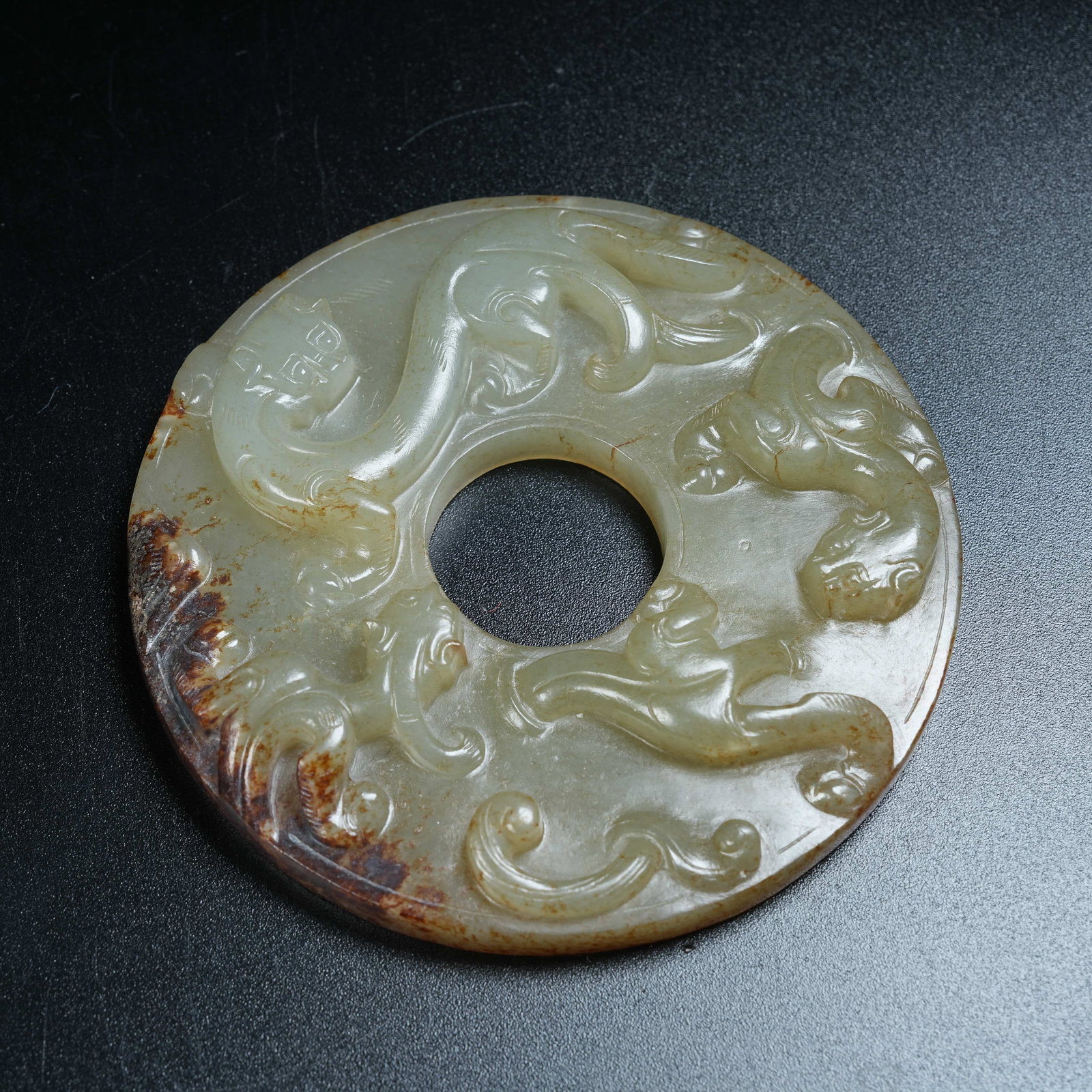 A ANCIENT JADE BI DISC CARVED WITH CHI DRAGONS: Ancient Jade Bi Disc Carved with Chi Dragons